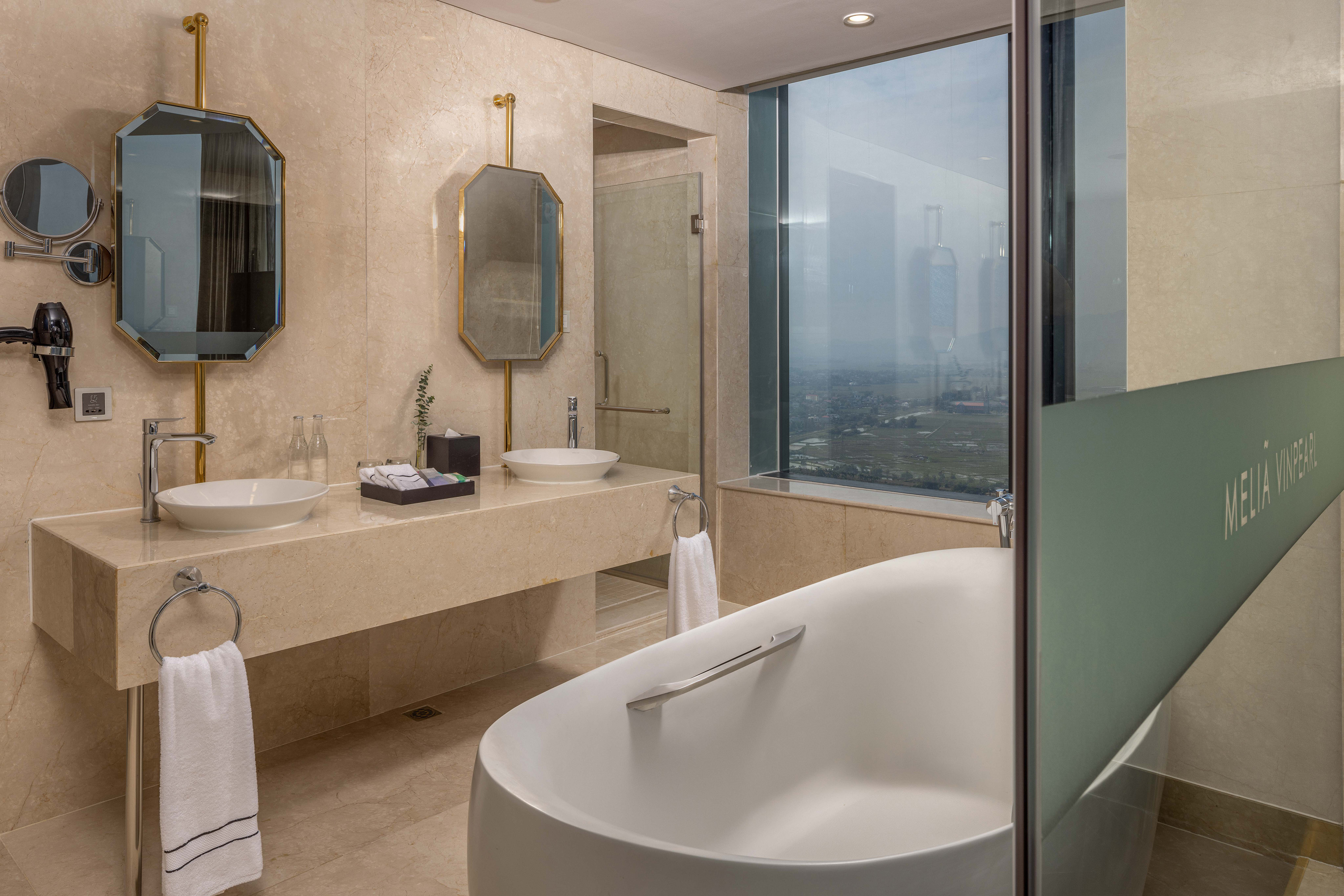 a bathroom with a tub and sinks