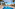 Luxury resort swimming pool with palm trees, lounge chairs, and hotel buildings.