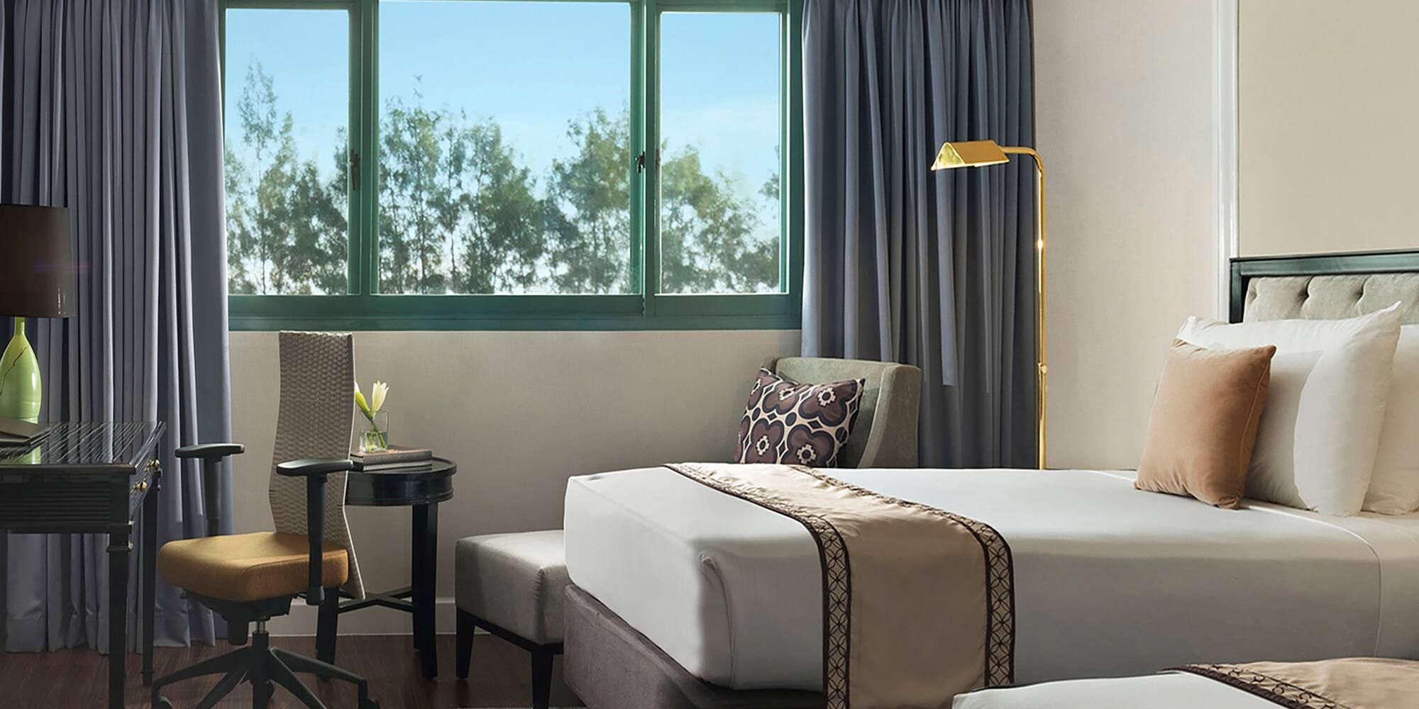 a hotel room with two beds and a desk