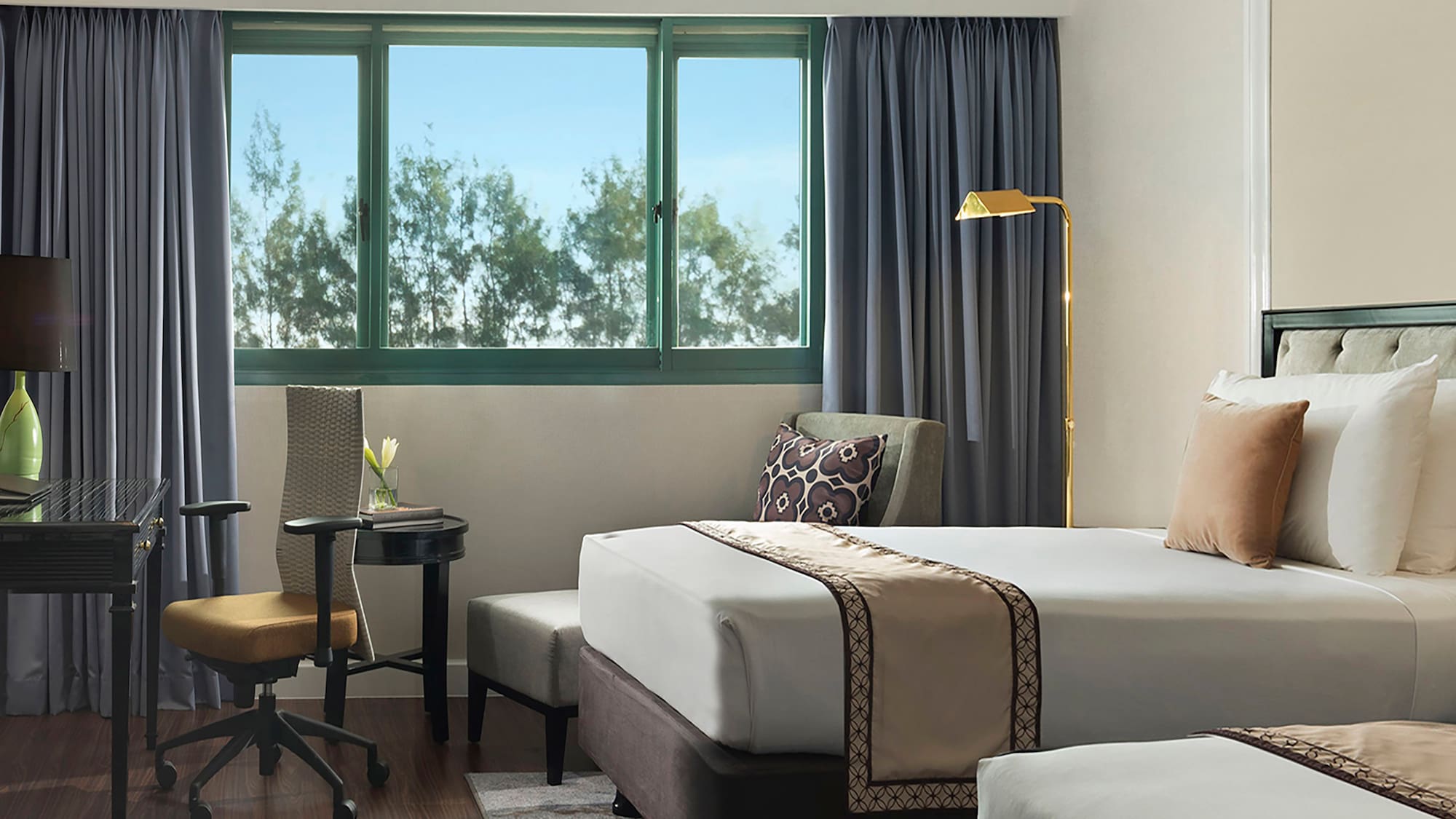 a hotel room with two beds and a desk