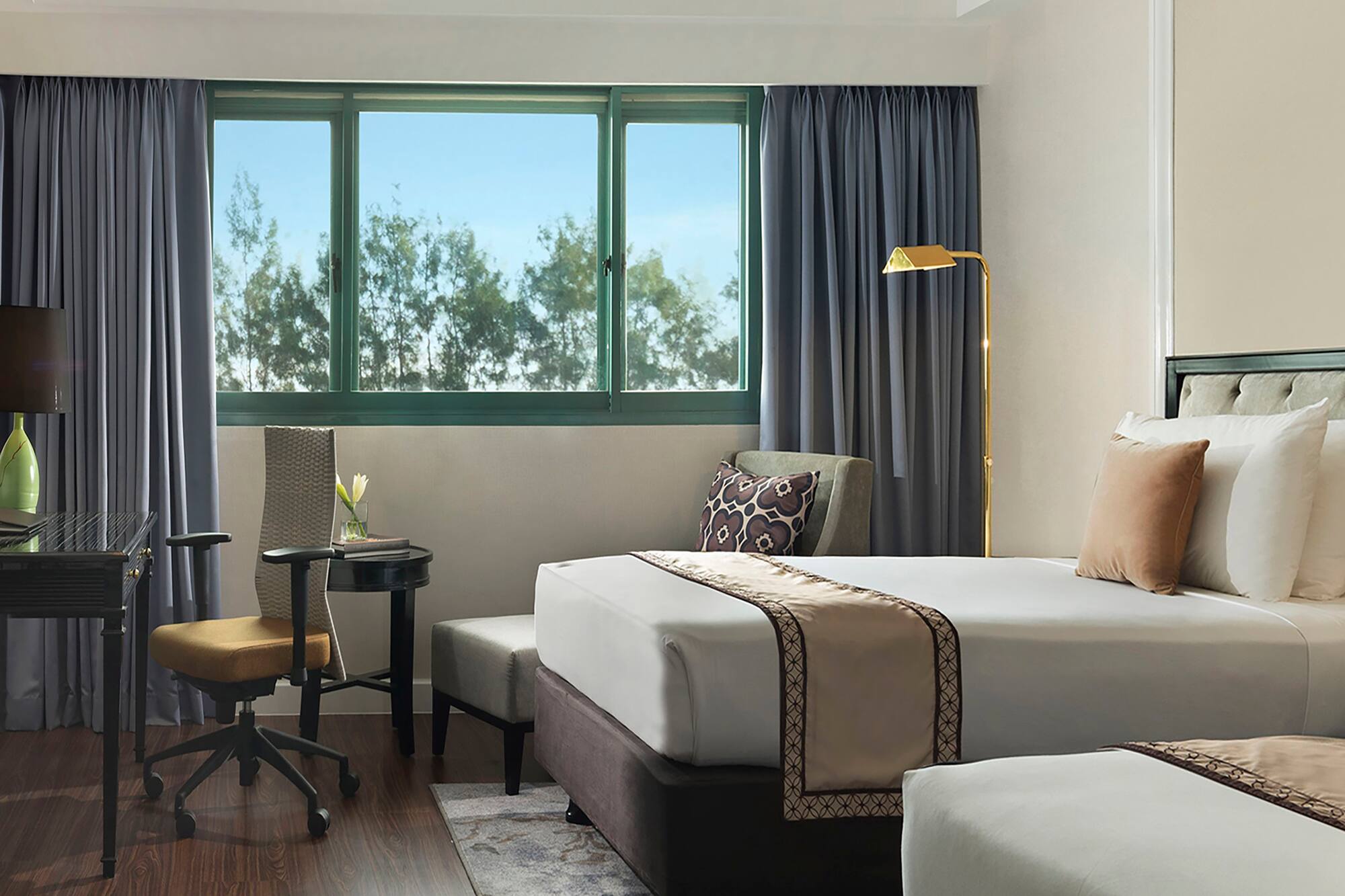 a hotel room with two beds and a desk