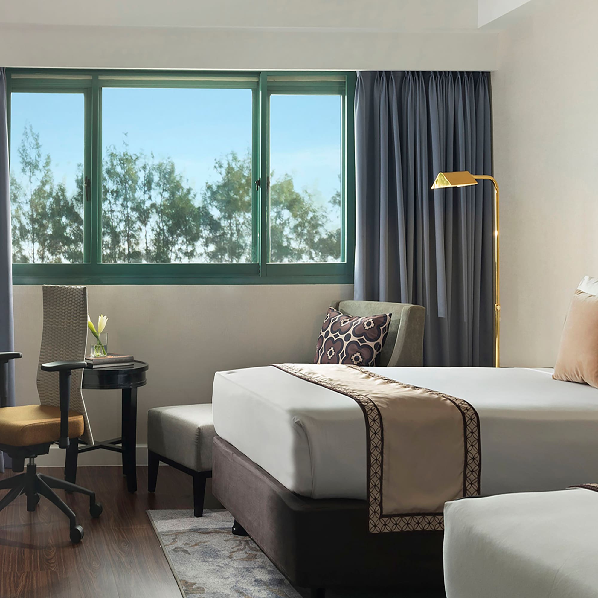 a hotel room with two beds and a desk