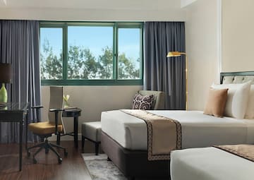 a hotel room with two beds and a desk