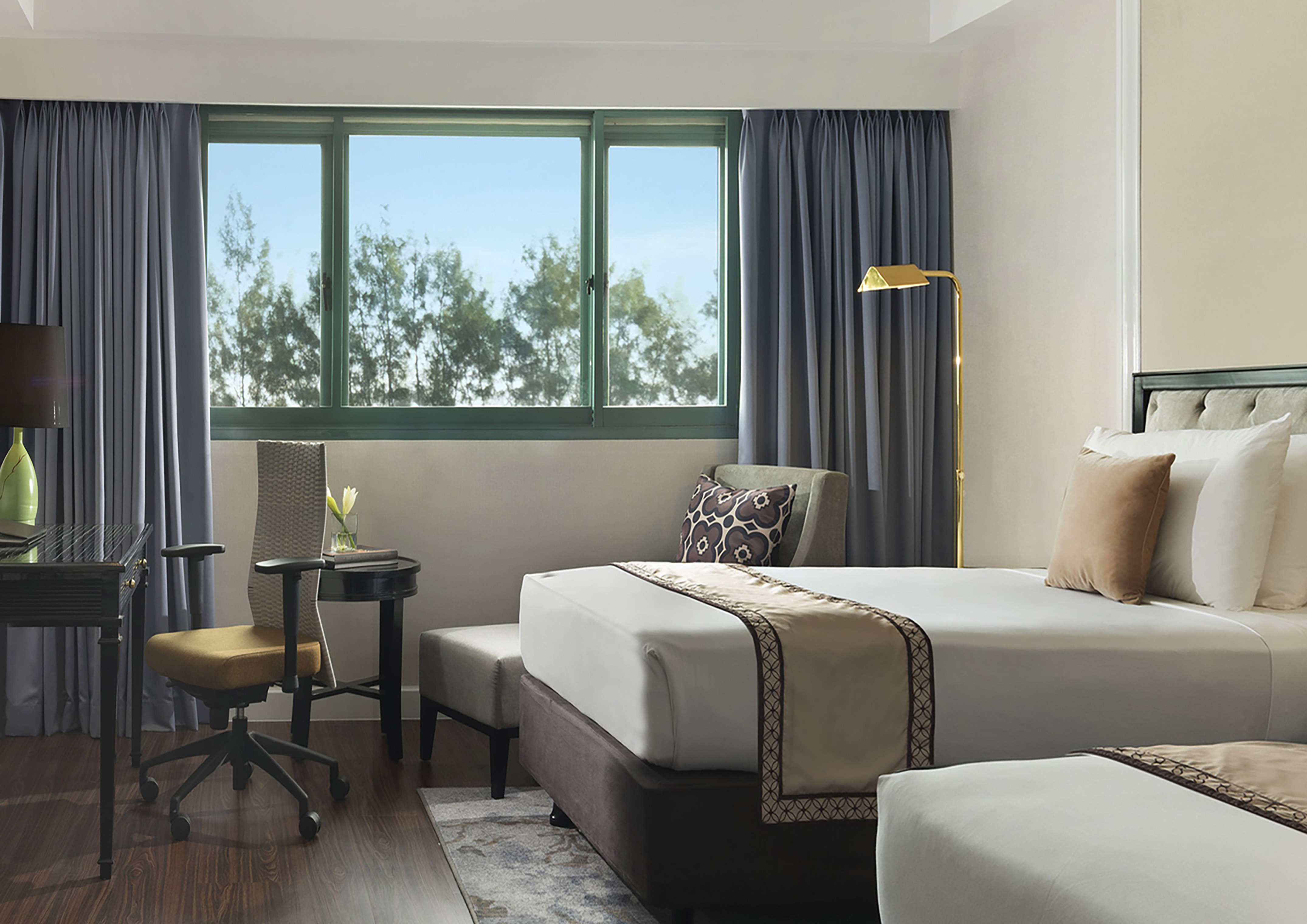 a hotel room with two beds and a desk