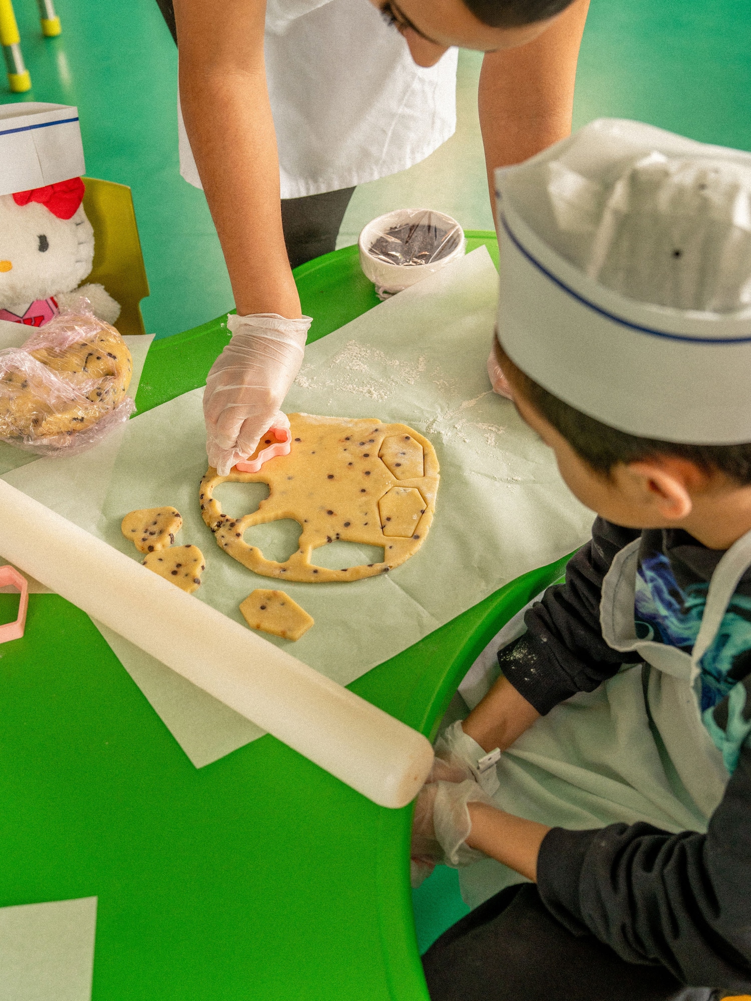 a person in a chef's hat making cookies