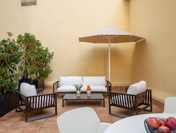 a patio with chairs and a table