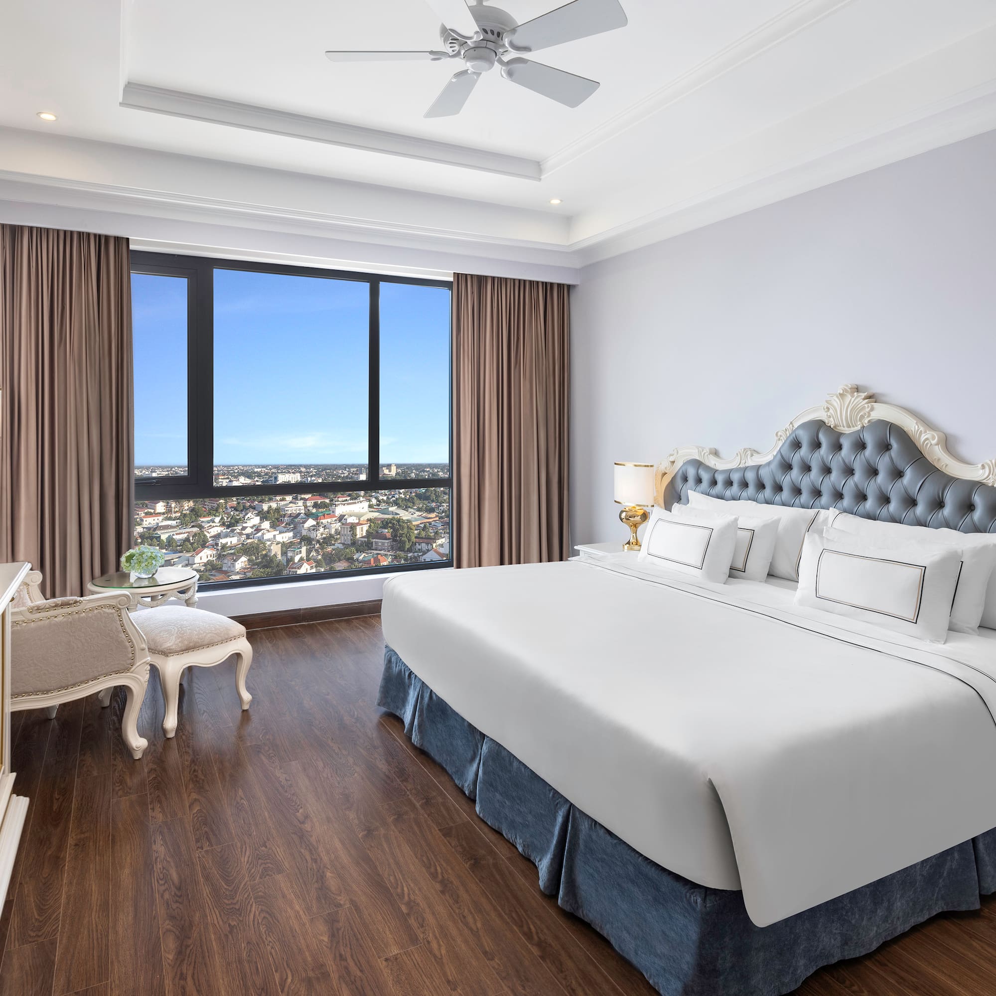 a bedroom with a large window and a large bed