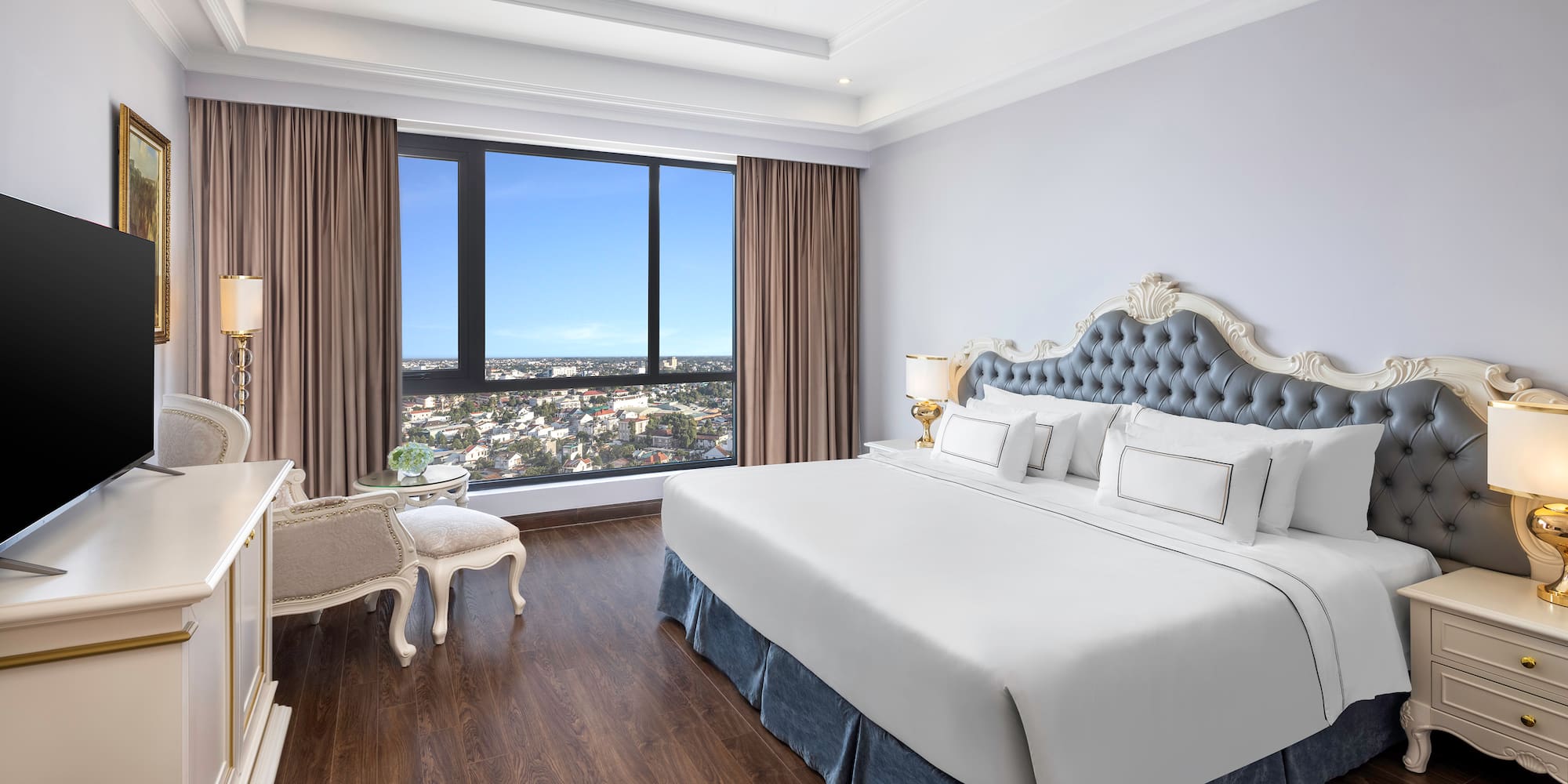 a bedroom with a large window and a large bed