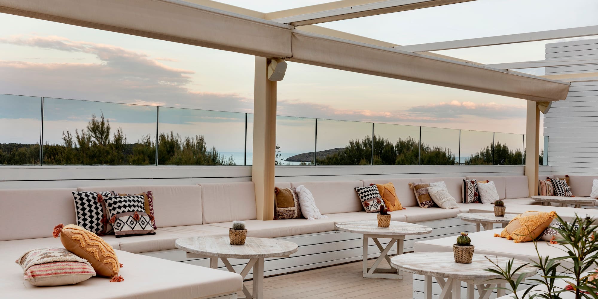 a patio with white furniture and tables