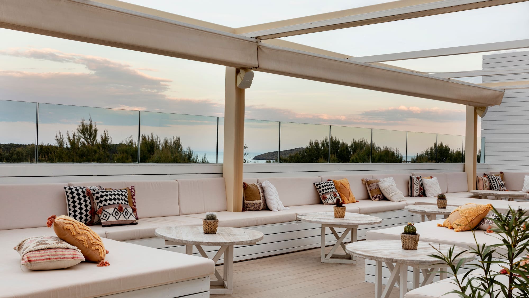 a patio with white furniture and tables