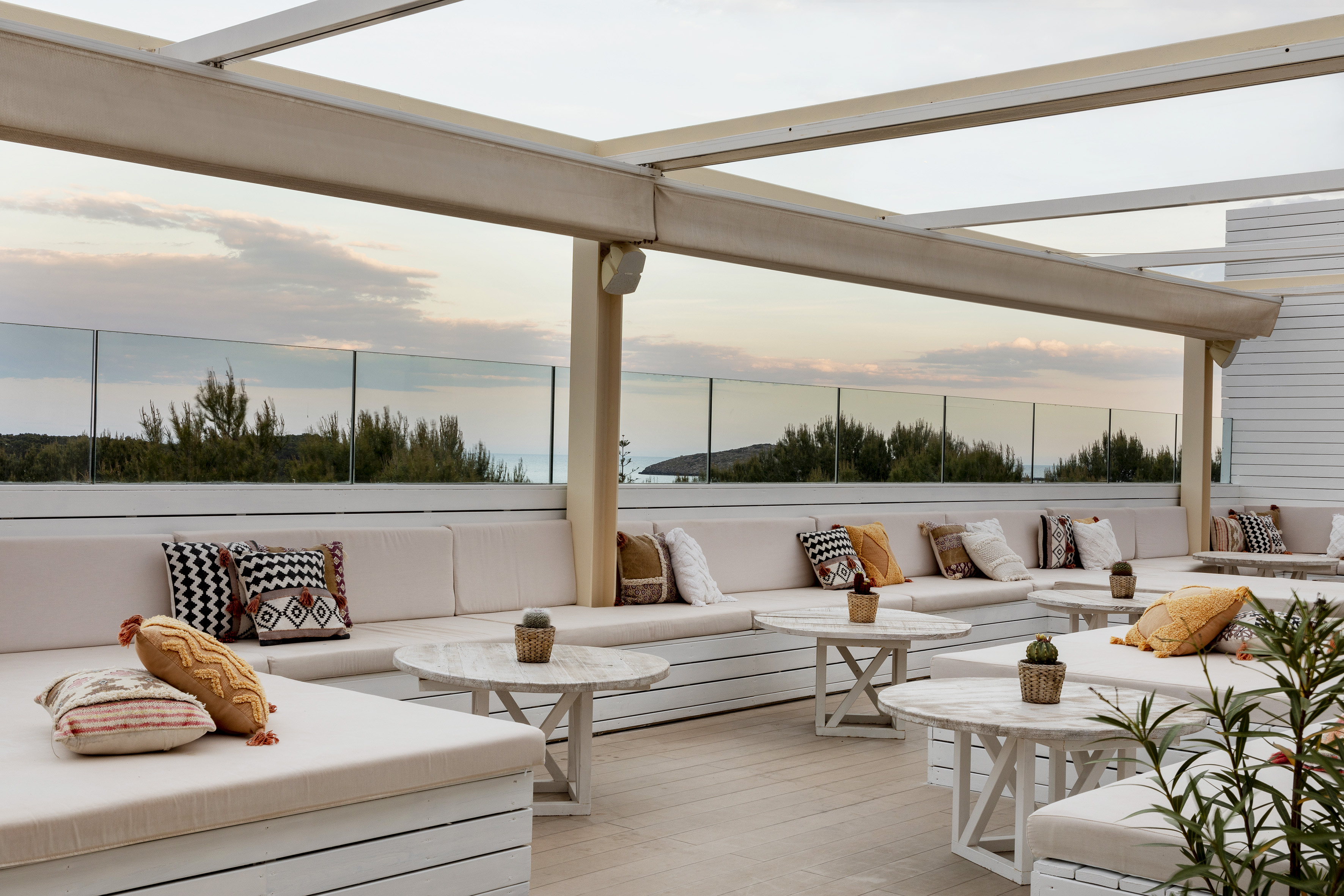a patio with white furniture and tables