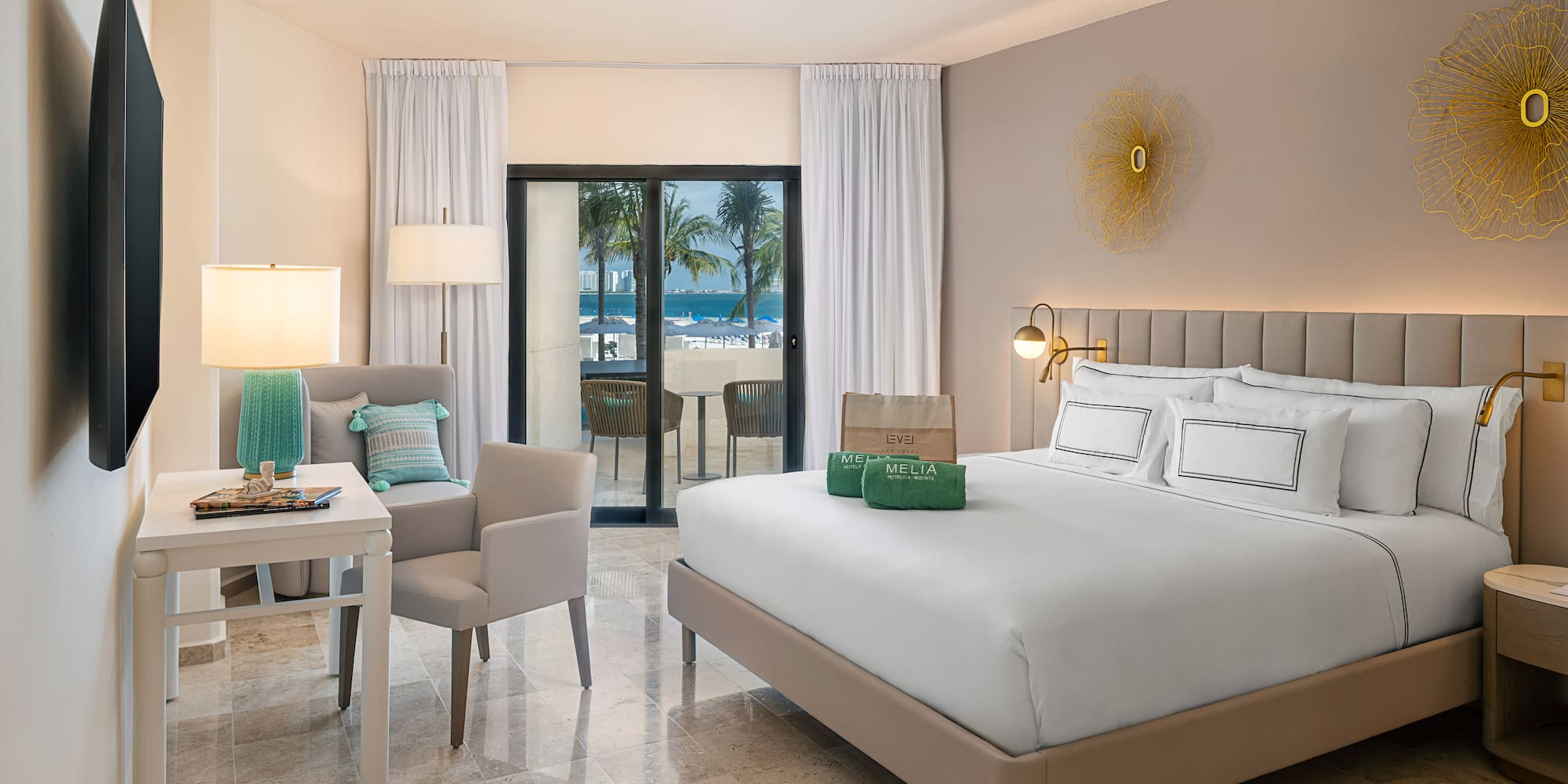 a room with a bed and chairs