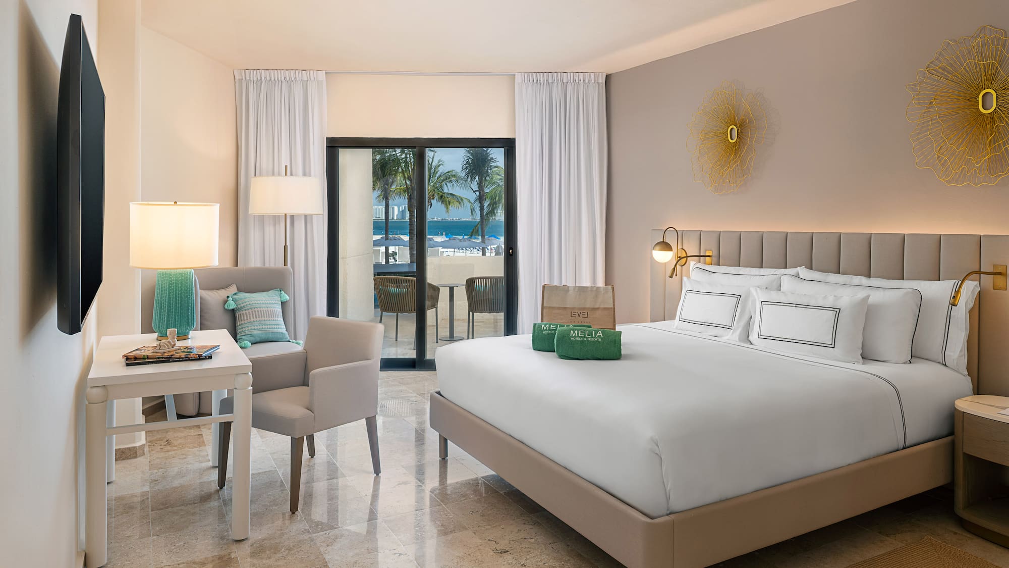 a room with a bed and chairs