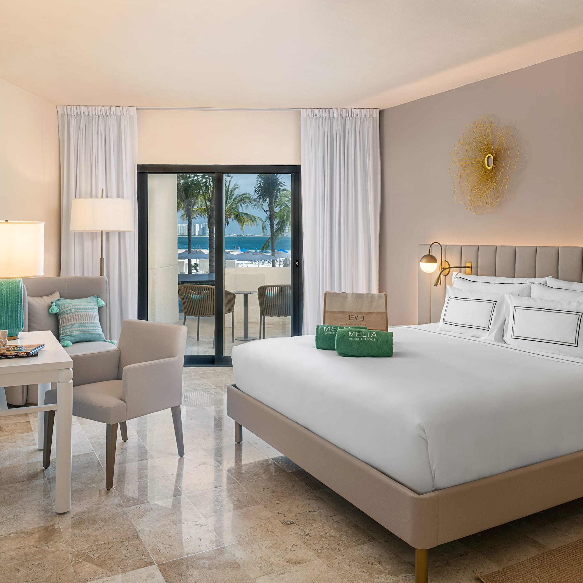 a room with a bed and chairs