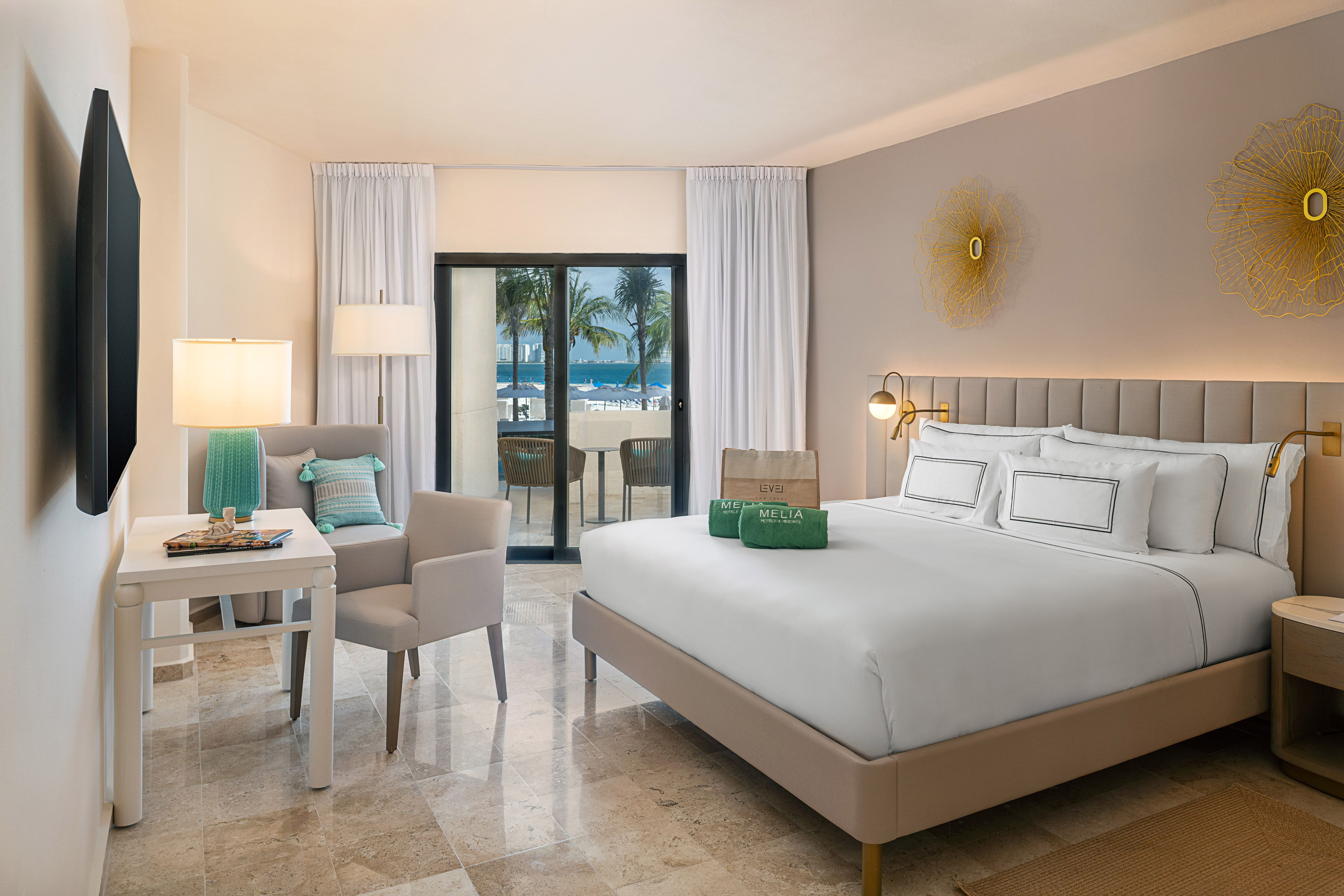 Melia hotel room with ocean view balcony, king bed, and modern tropical decor.