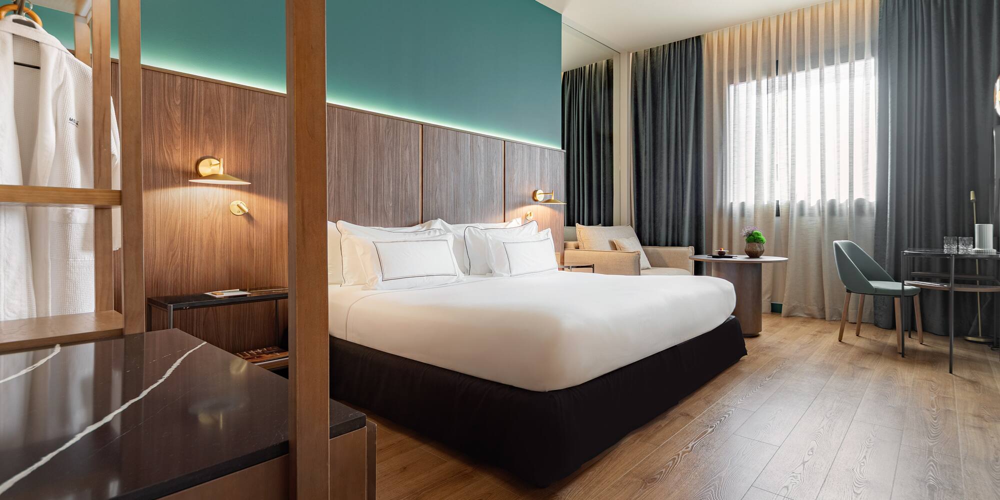 a room with a bed and a wood floor