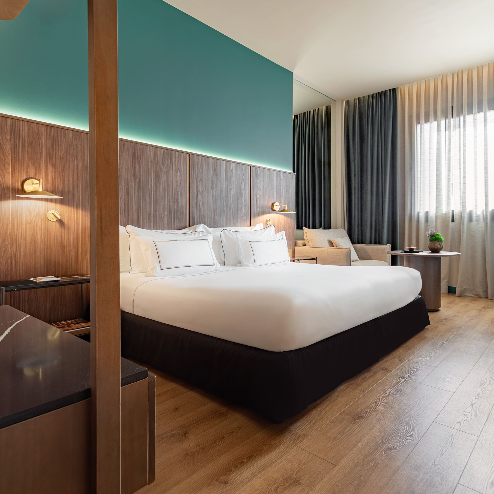 a room with a bed and a wood floor