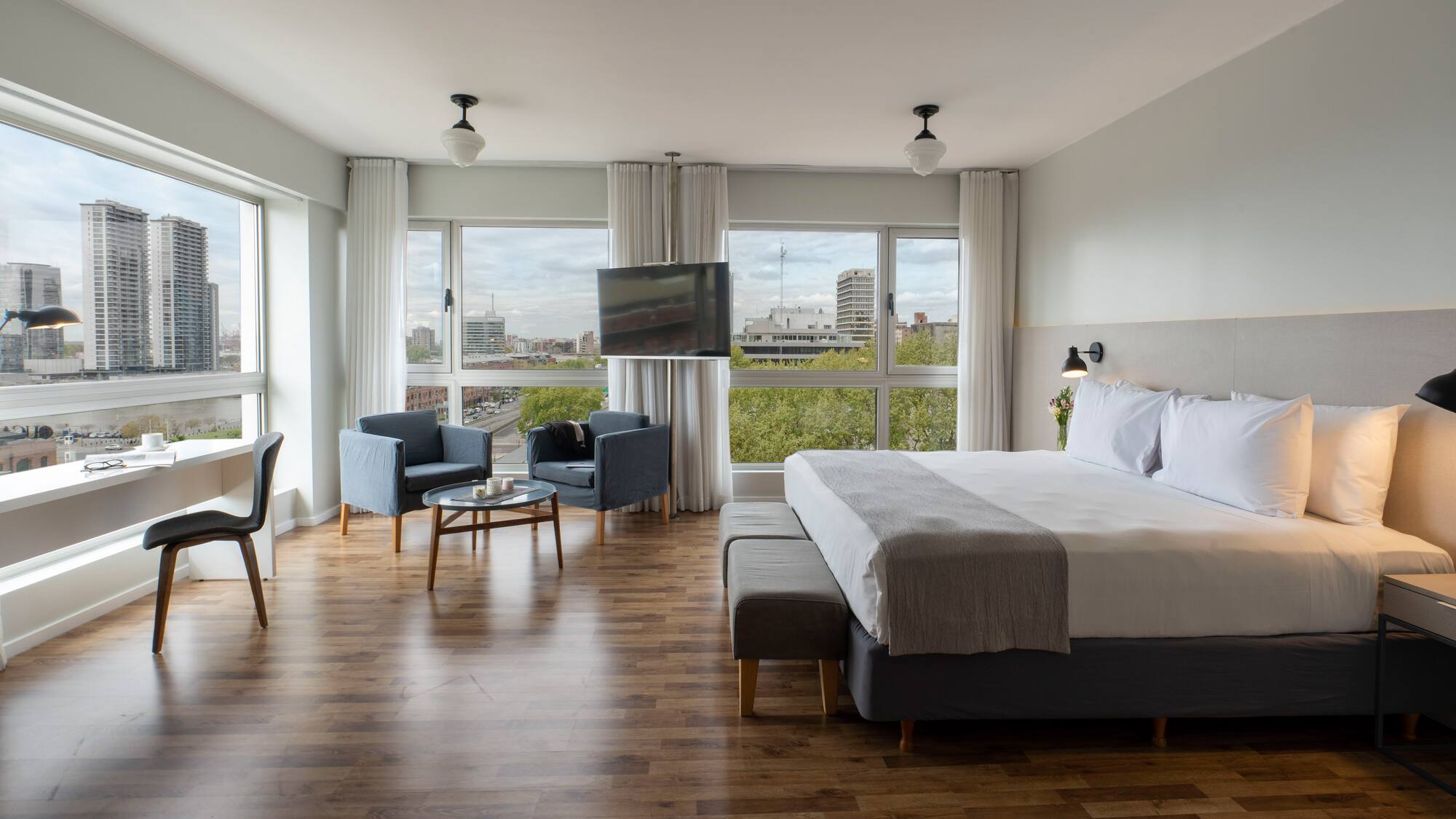 a bedroom with a large bed and a television