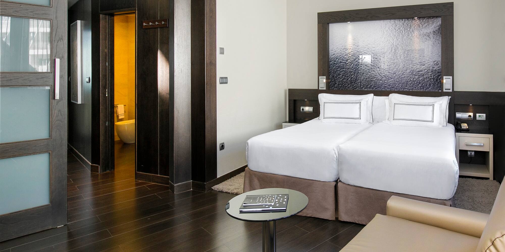 a room with two beds and a table