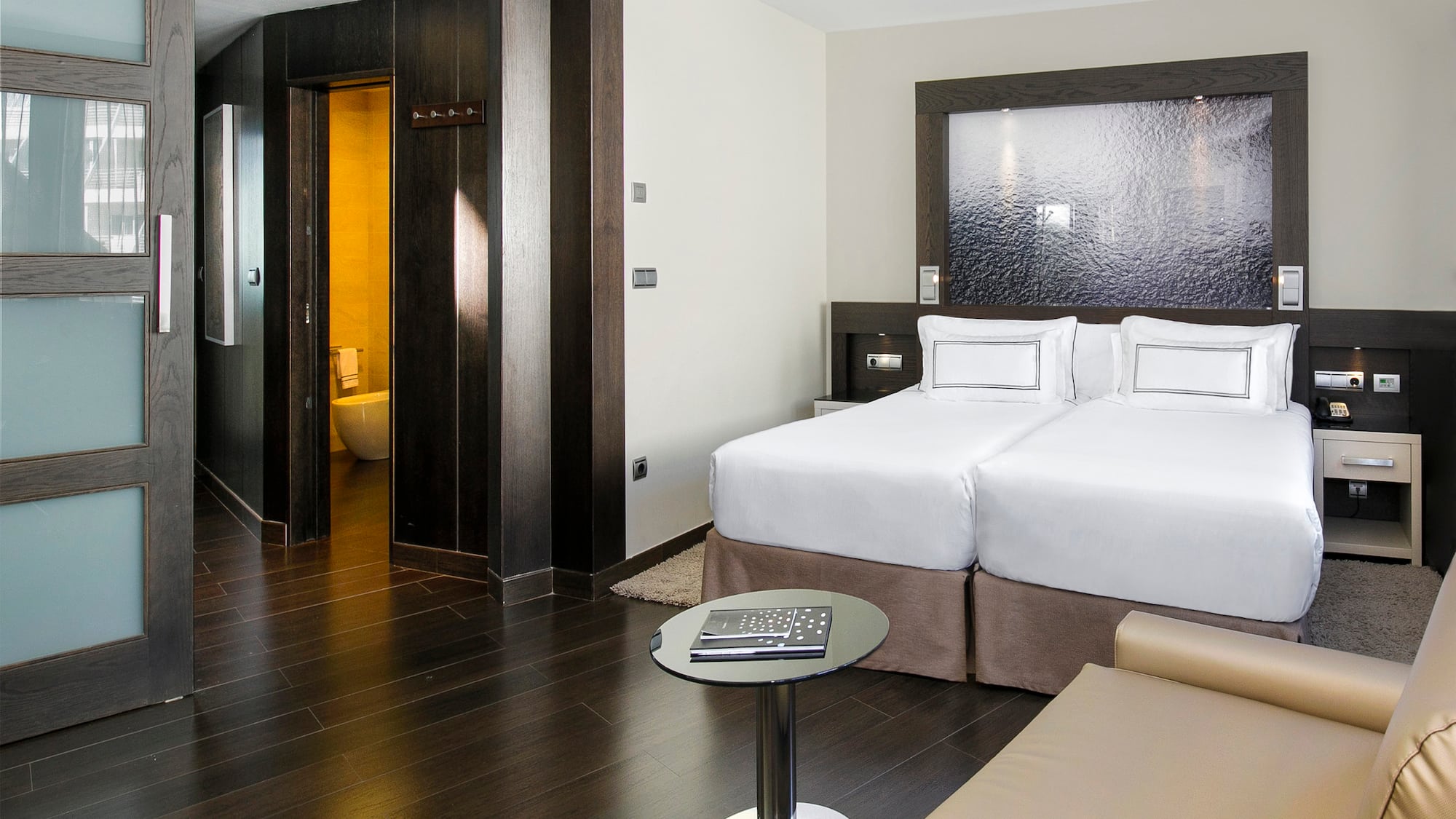 a room with two beds and a table