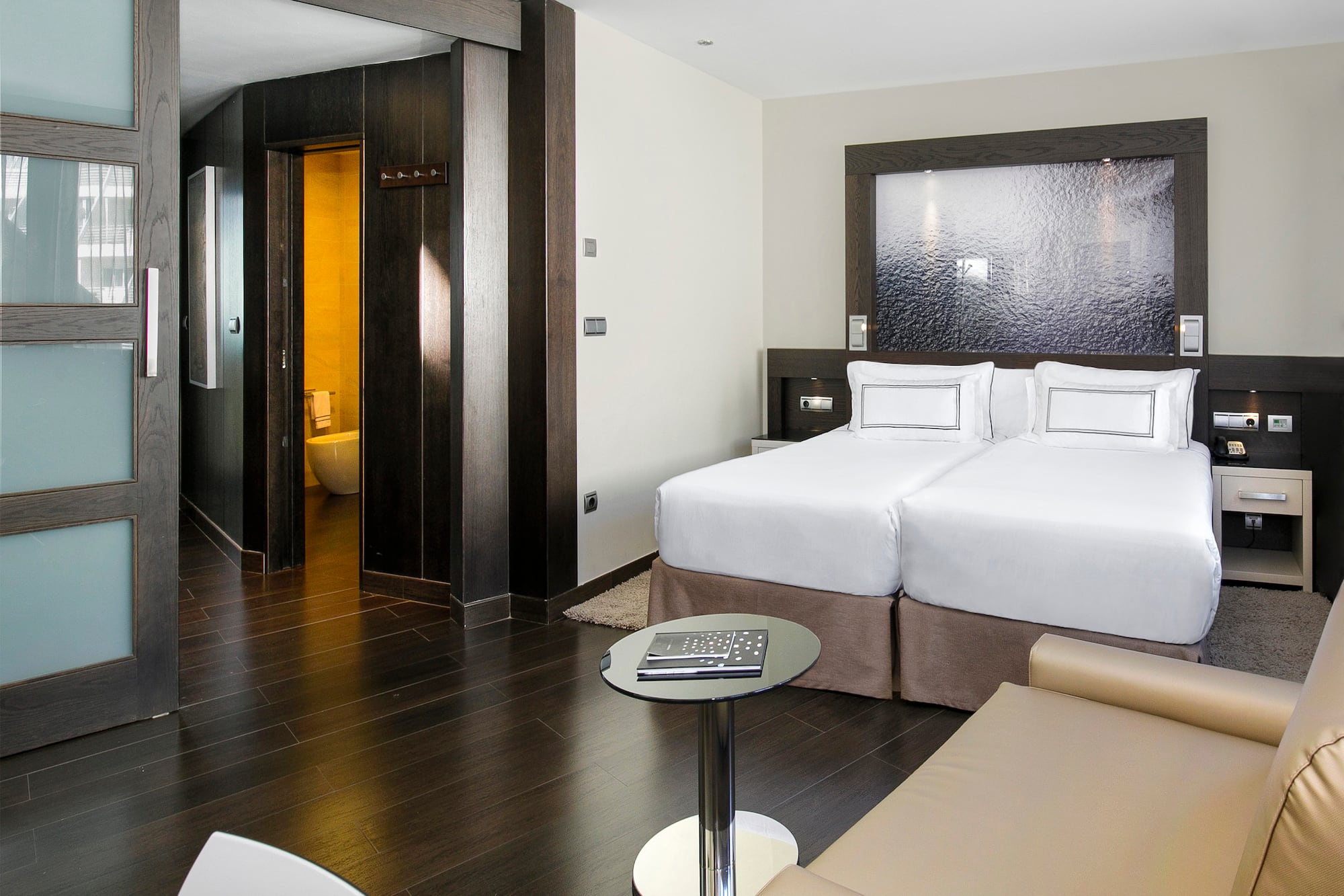 a room with two beds and a table