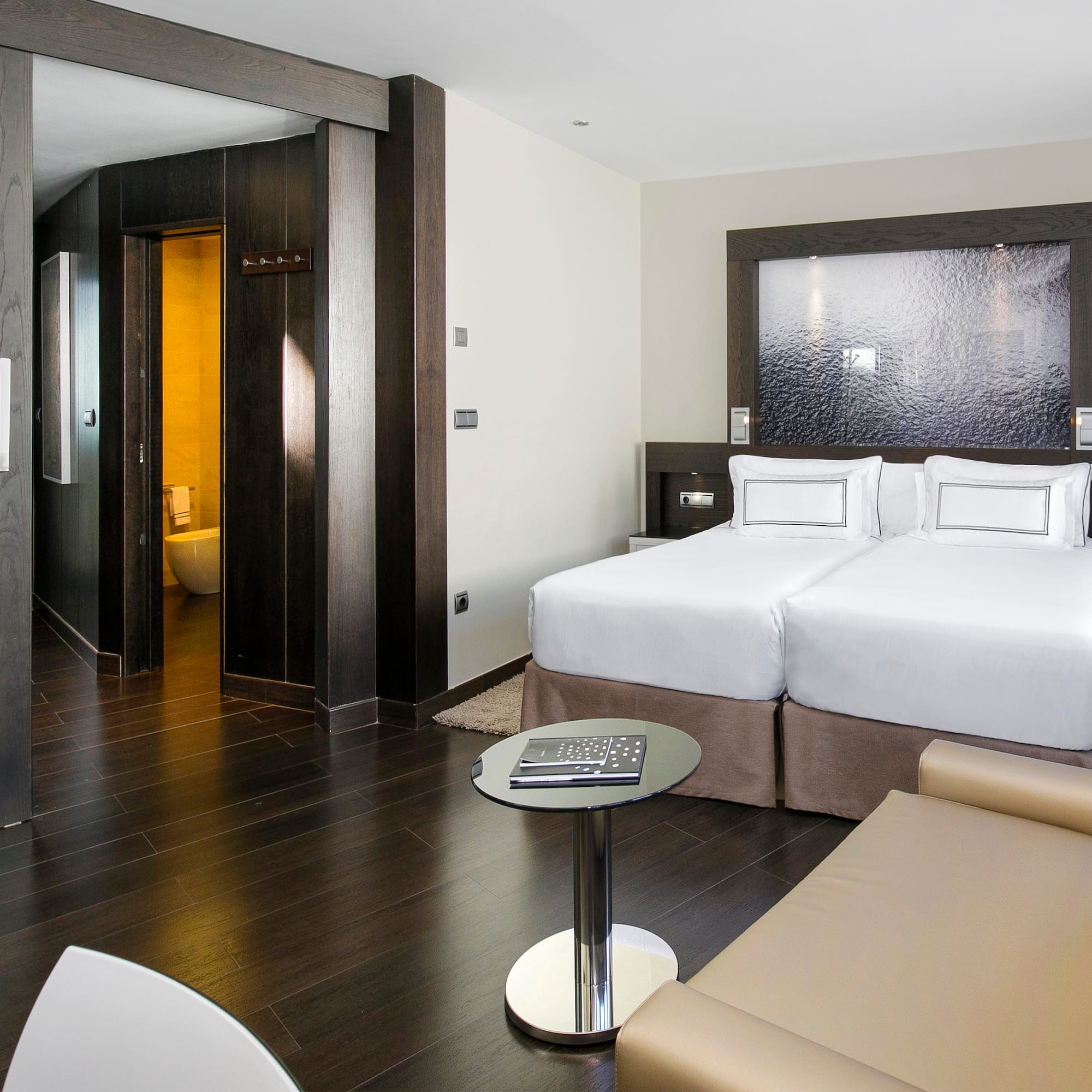 a room with two beds and a table