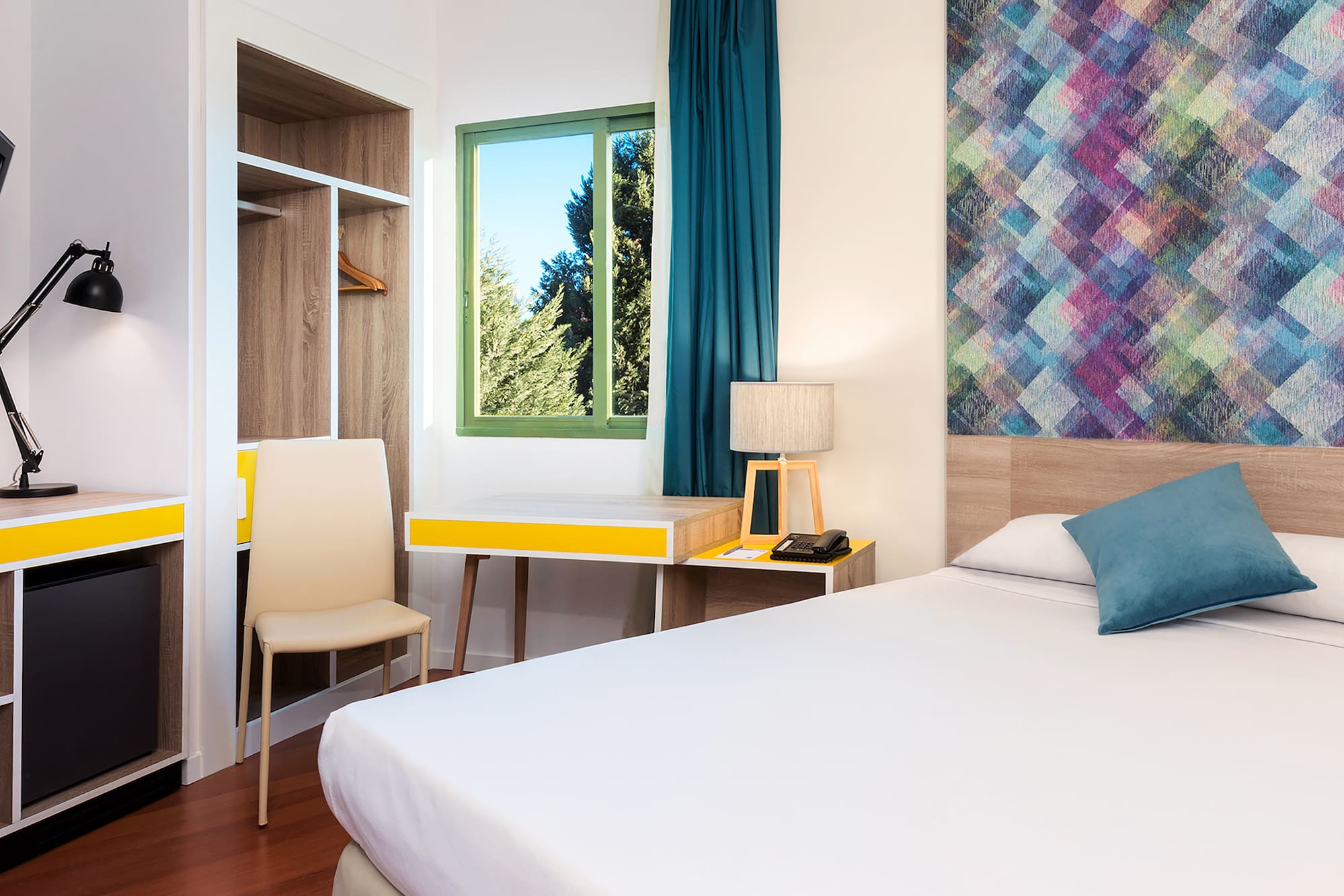 a room with a bed and a desk and chair