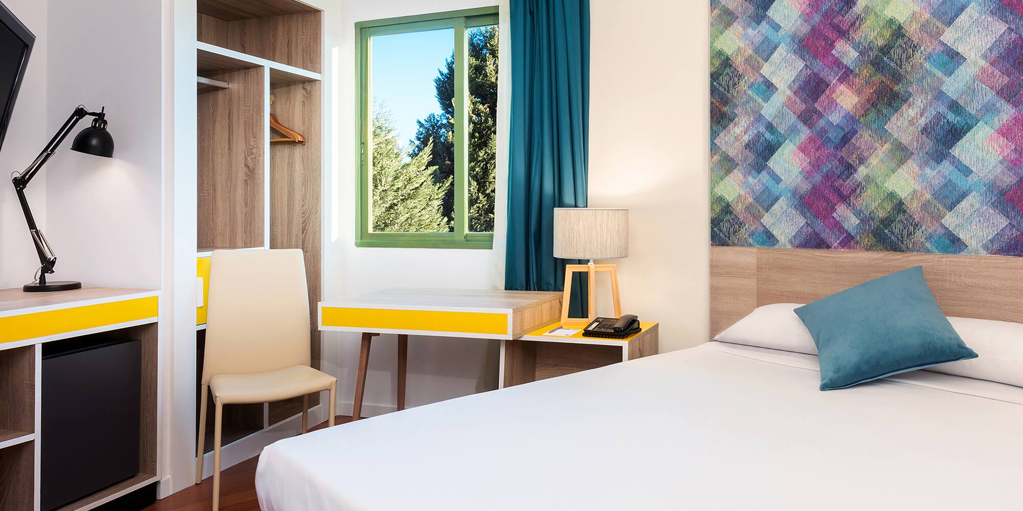 a room with a bed and a desk and chair