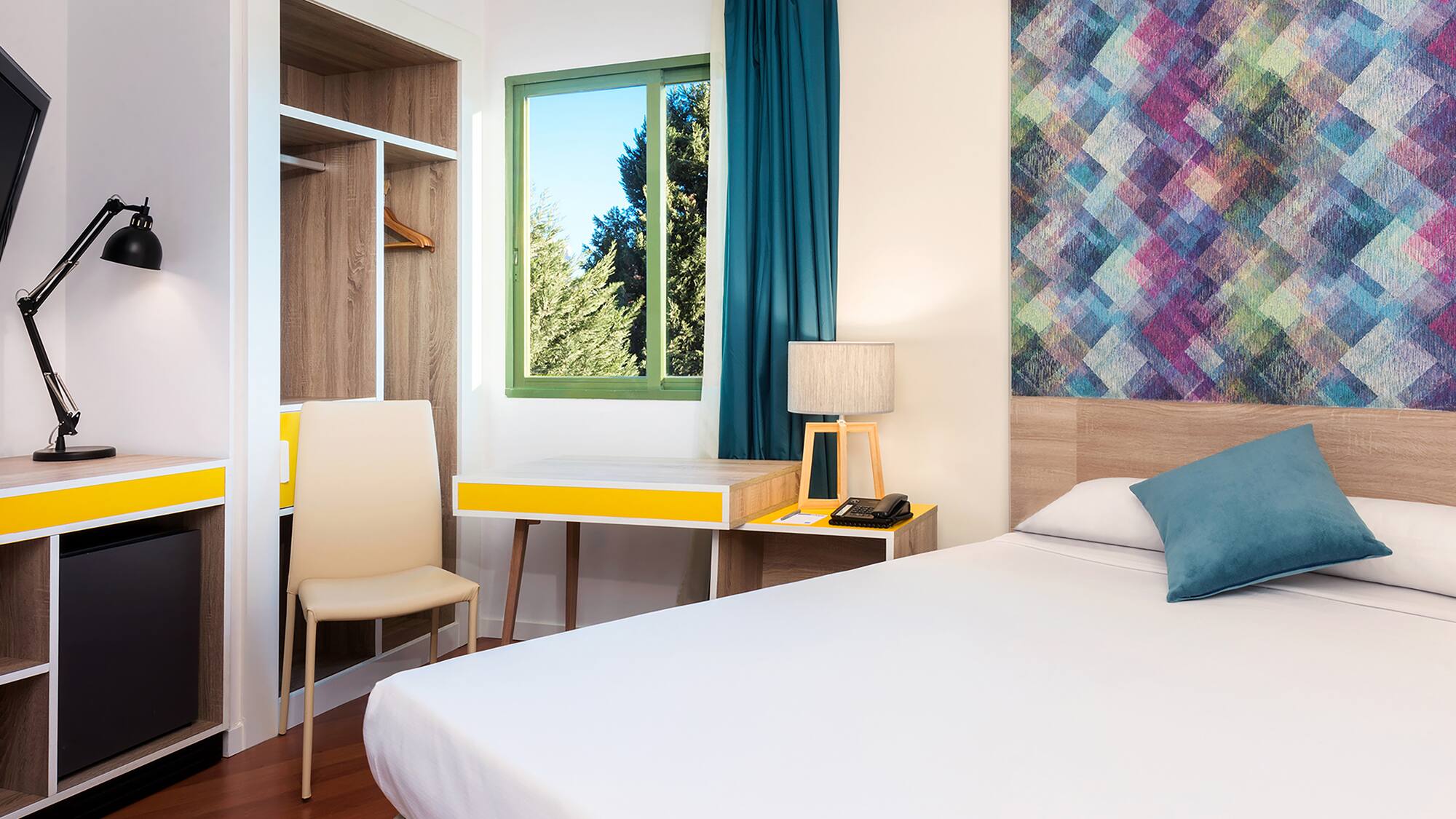 a room with a bed and a desk and chair