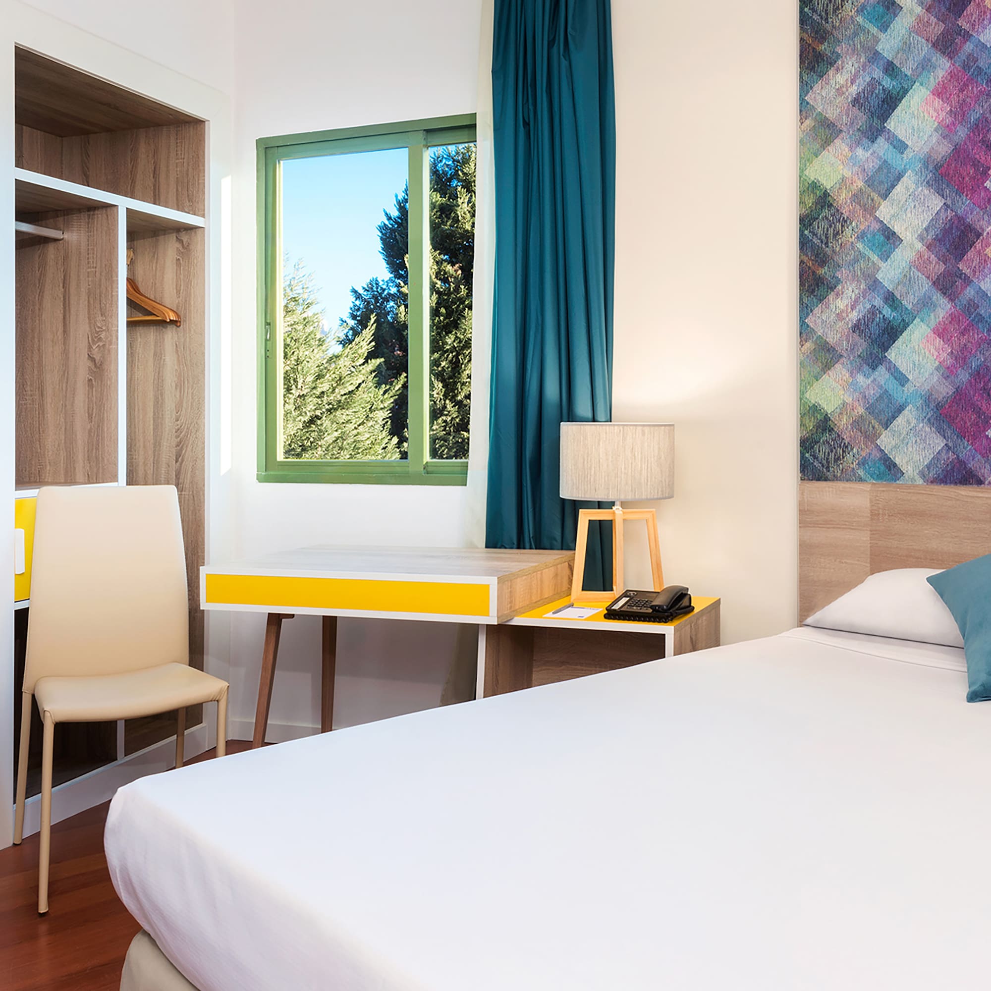 a room with a bed and a desk and chair