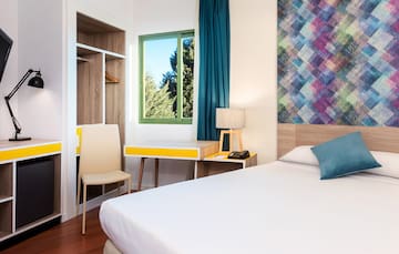 a room with a bed and a desk and chair