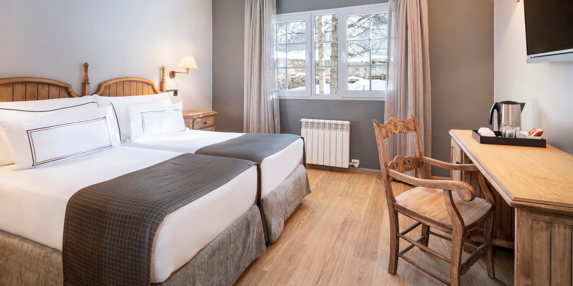 a room with two beds and a desk