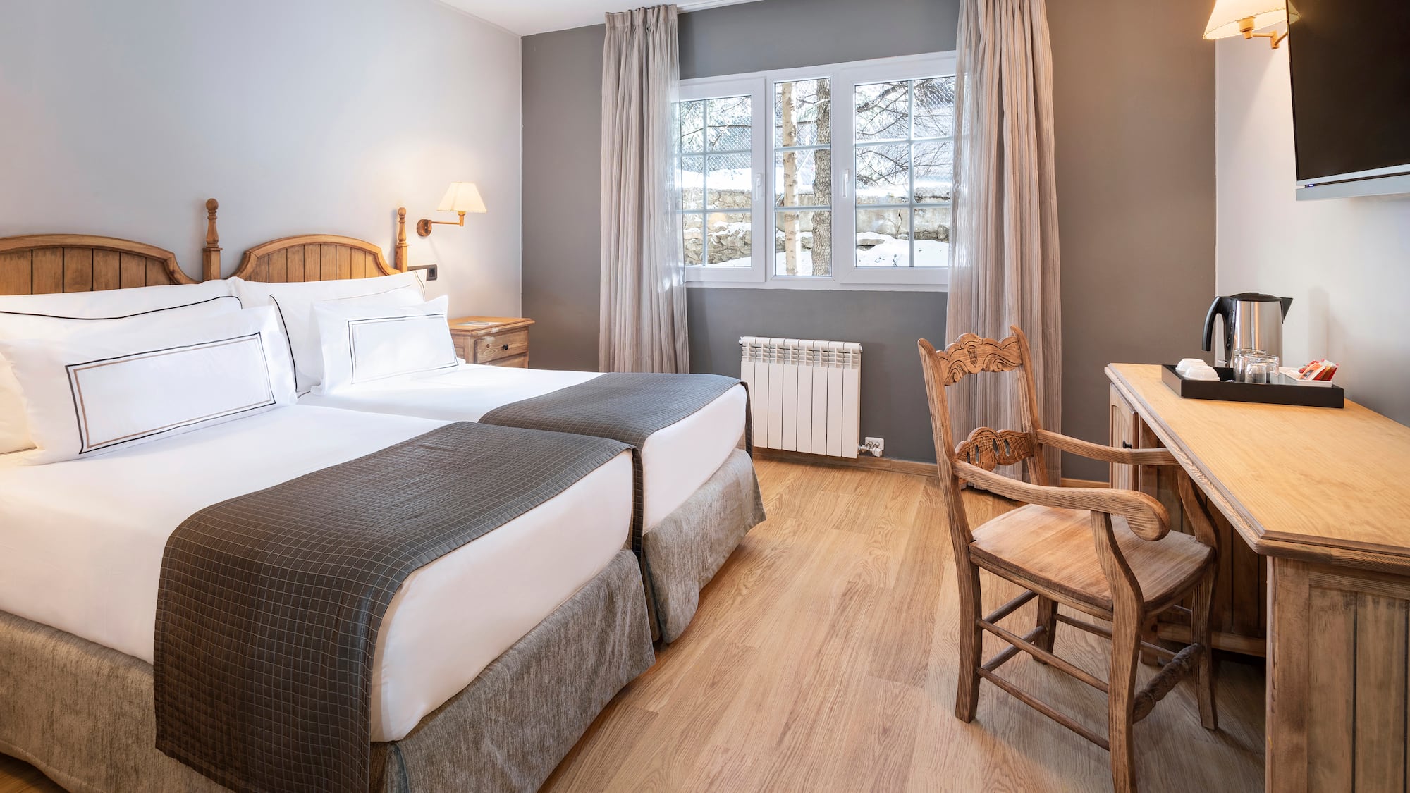 a room with two beds and a desk