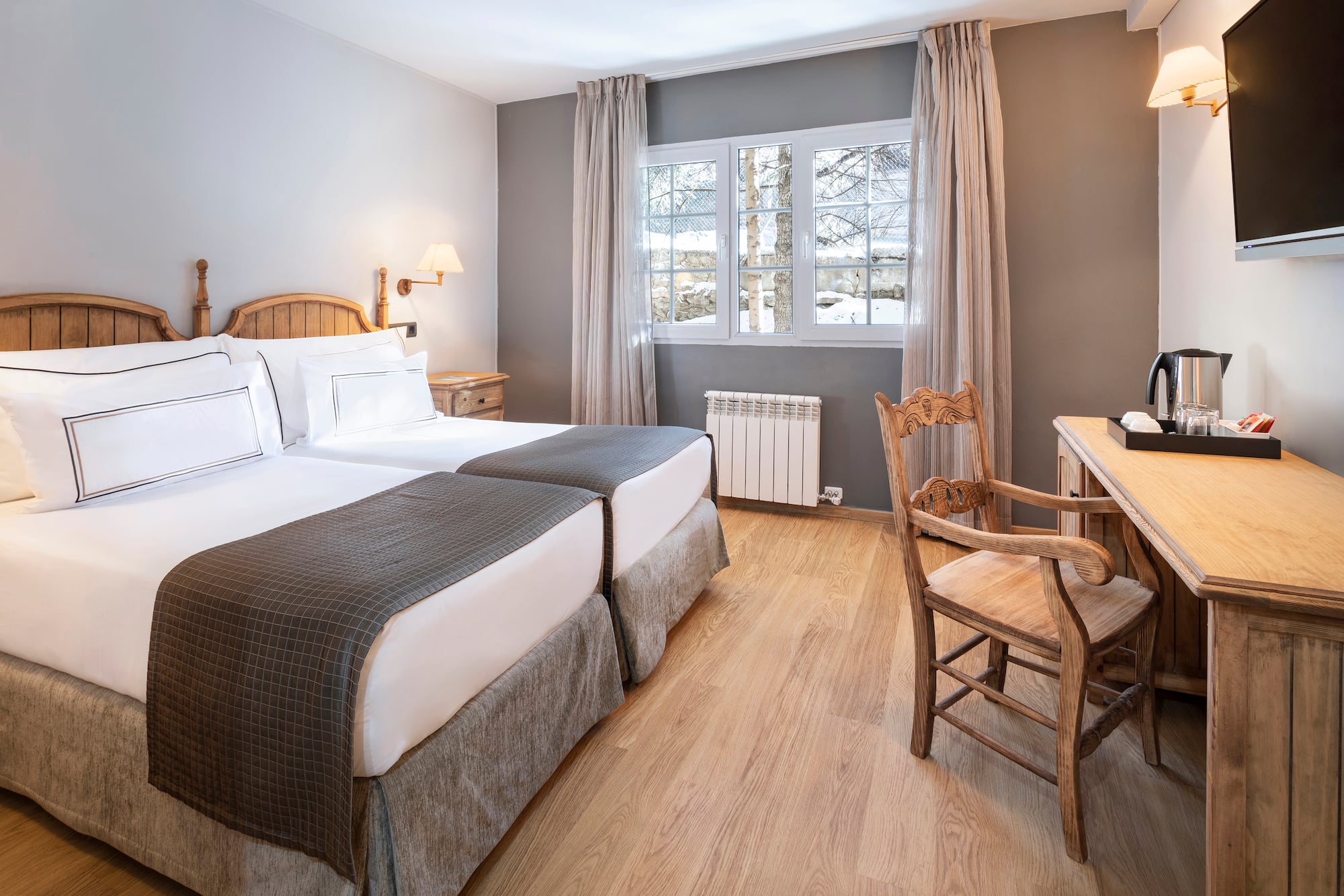 a room with two beds and a desk