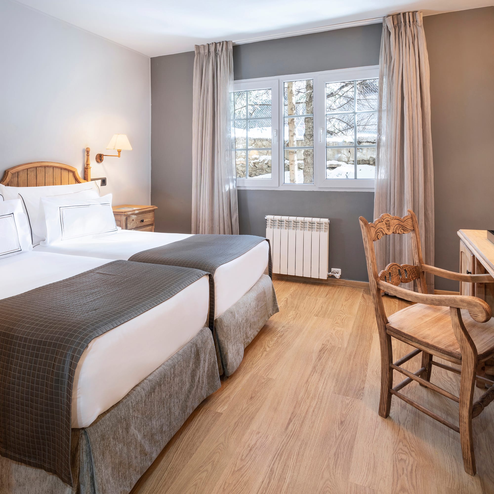 a room with two beds and a desk