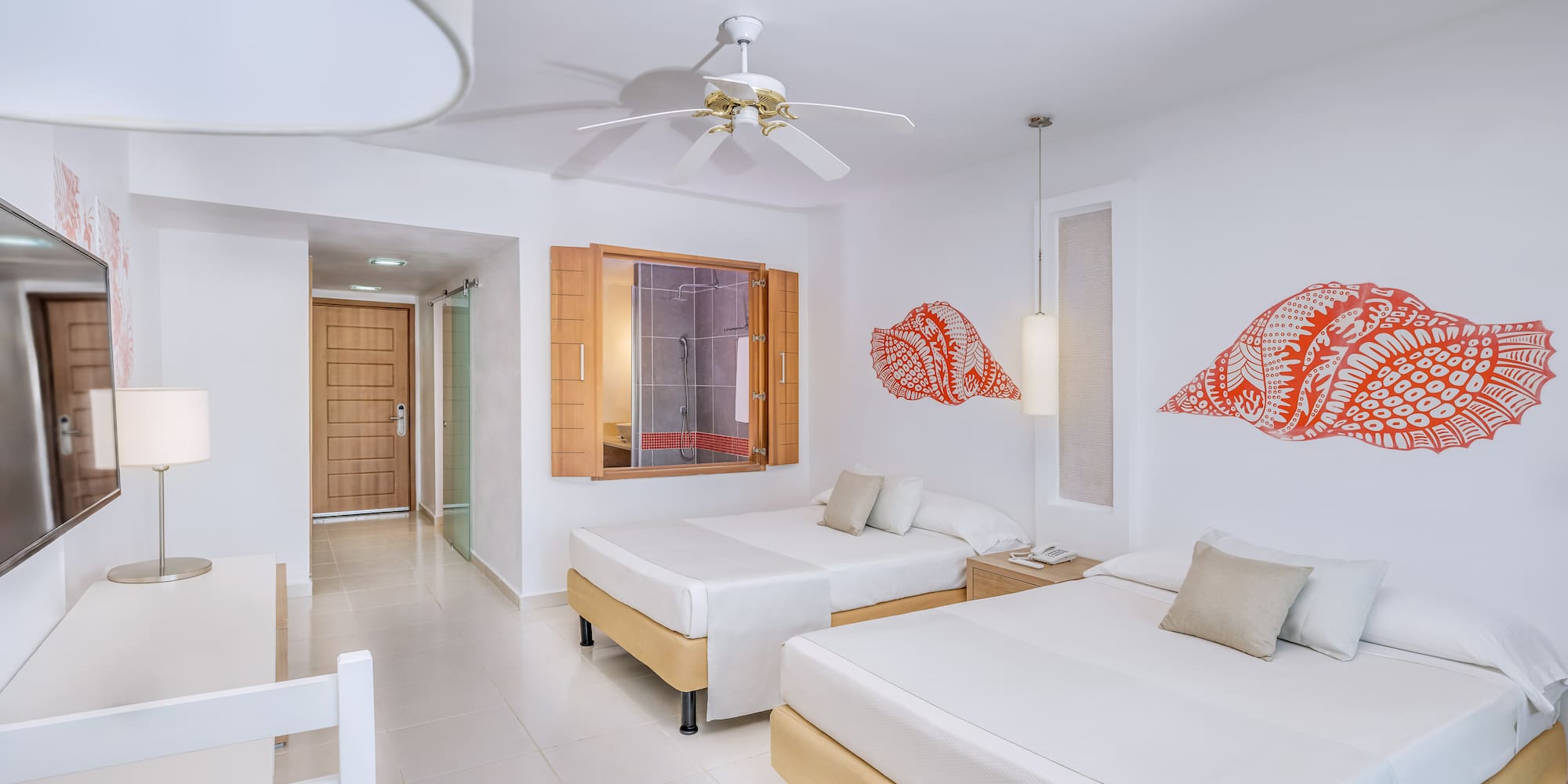 a room with two beds and a fan