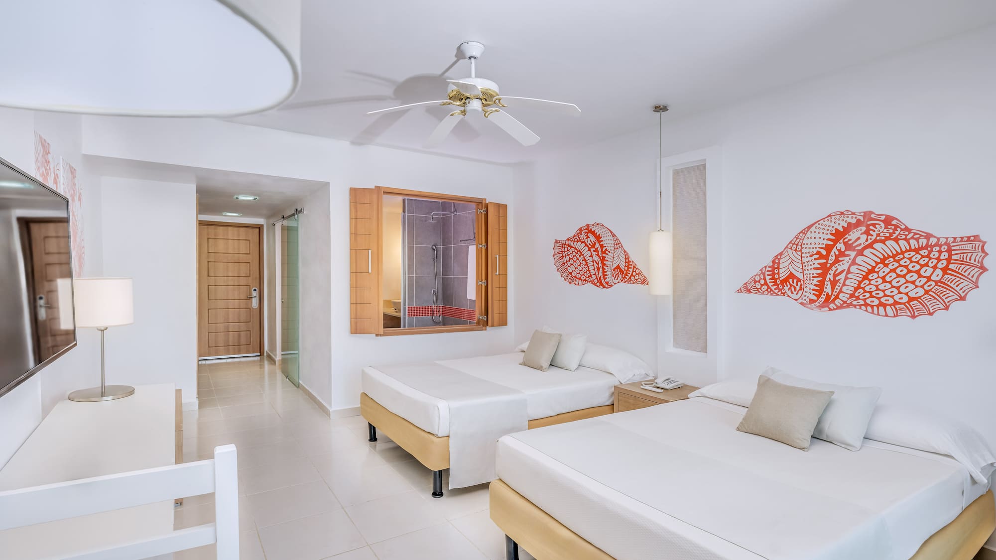 a room with two beds and a fan