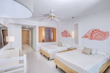 a room with two beds and a fan