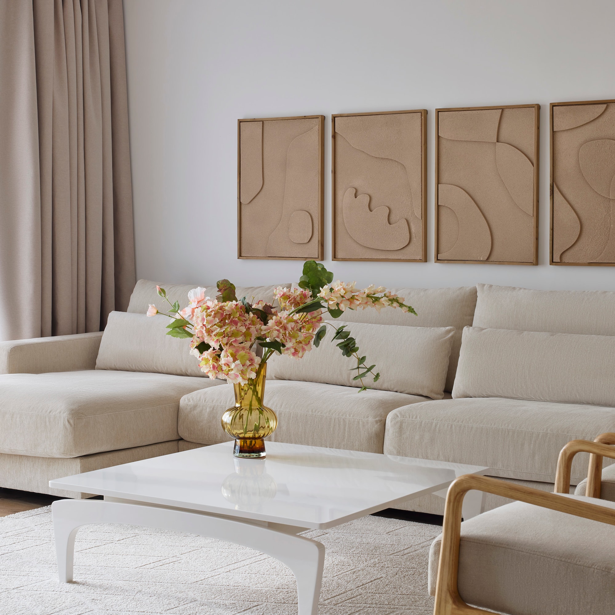 a living room with a couch and a vase of flowers