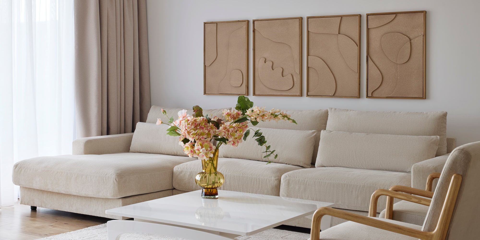 a living room with a couch and a vase of flowers