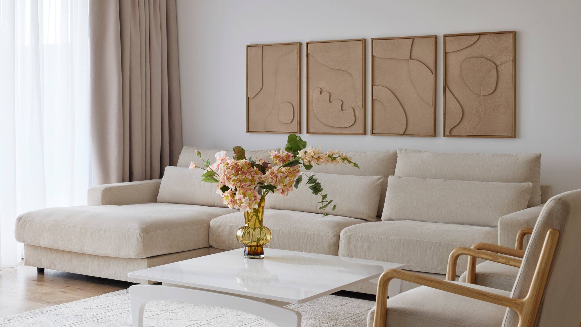 a living room with a couch and a vase of flowers