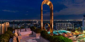 a rooftop with a pool and a large arch