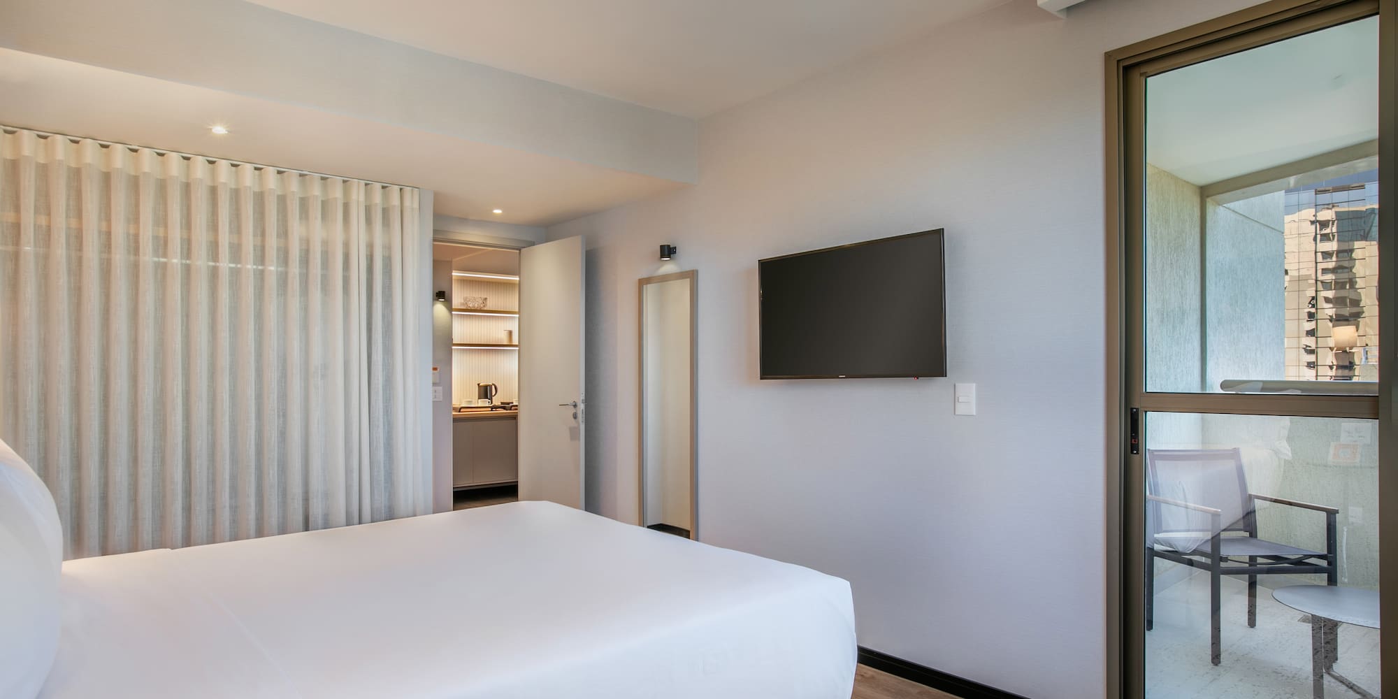 a bedroom with a bed and a television