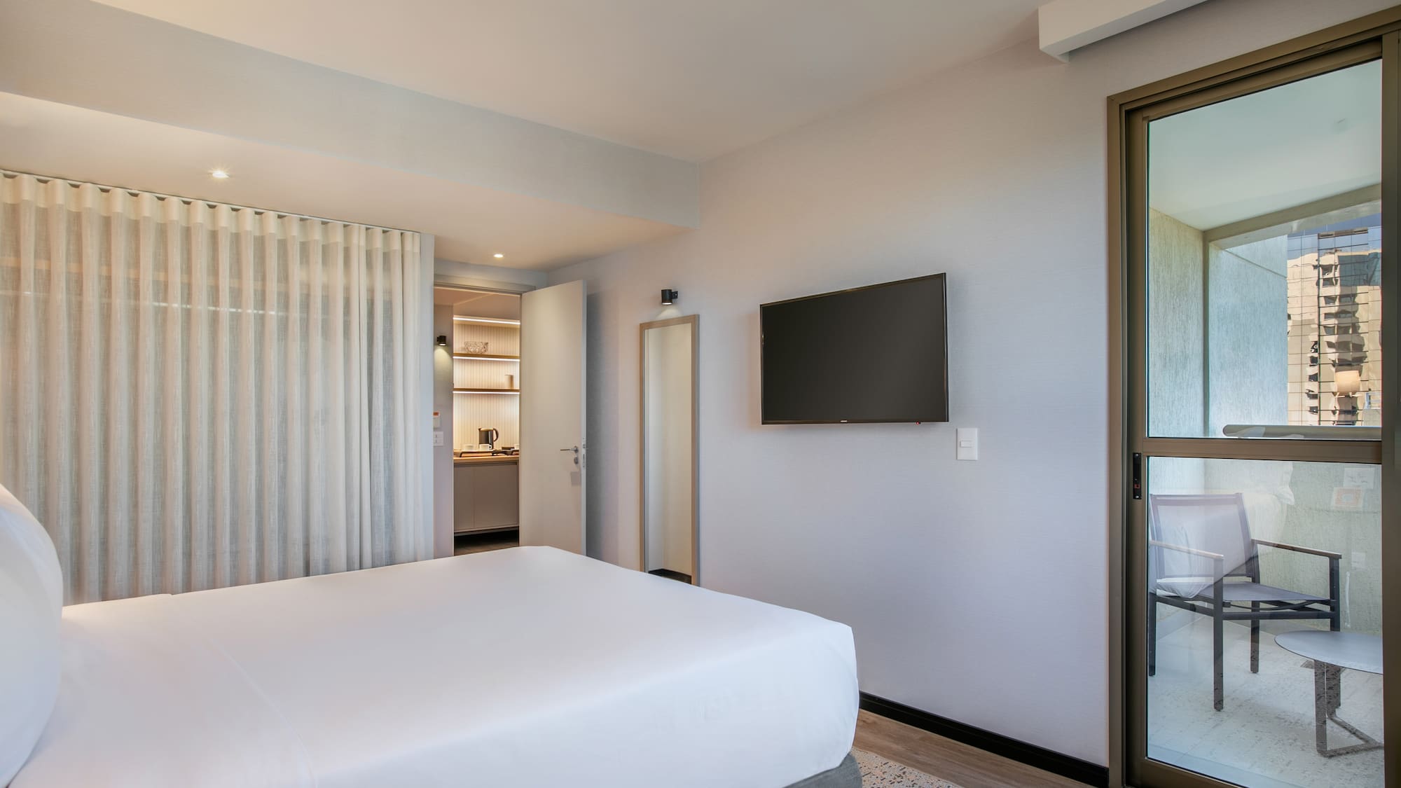 a bedroom with a bed and a television