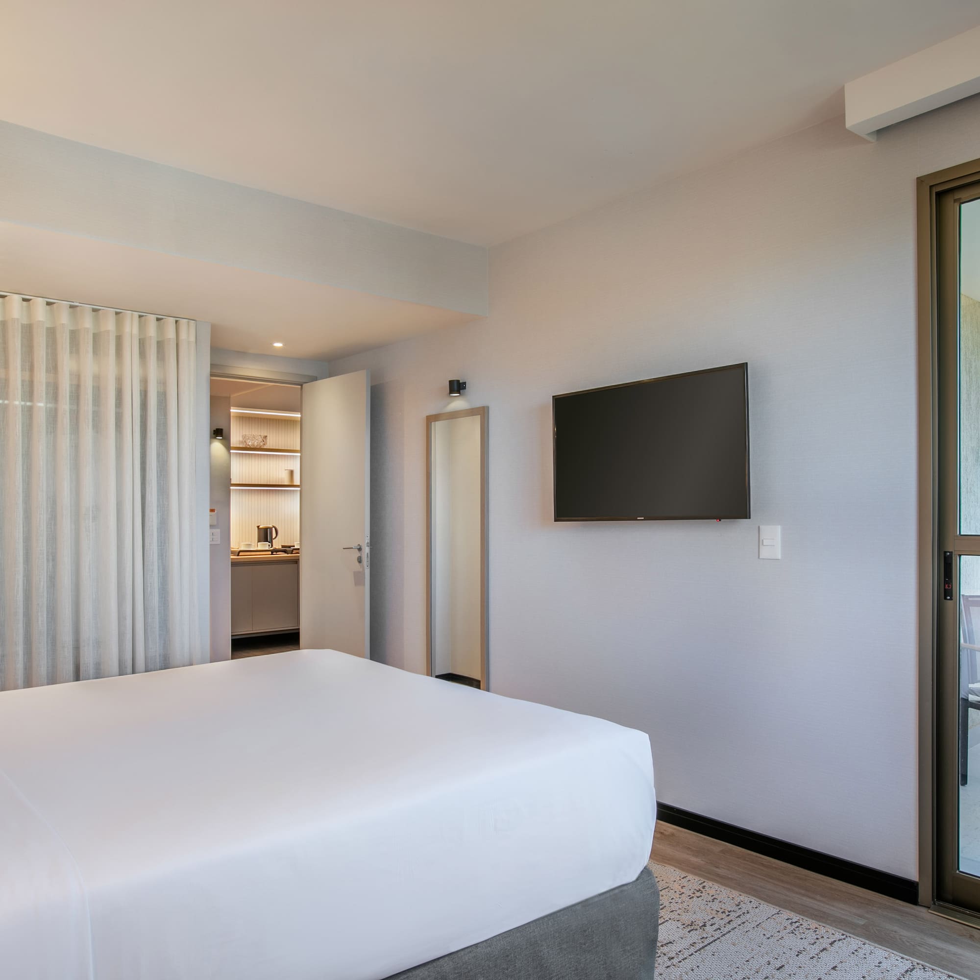 a bedroom with a bed and a television