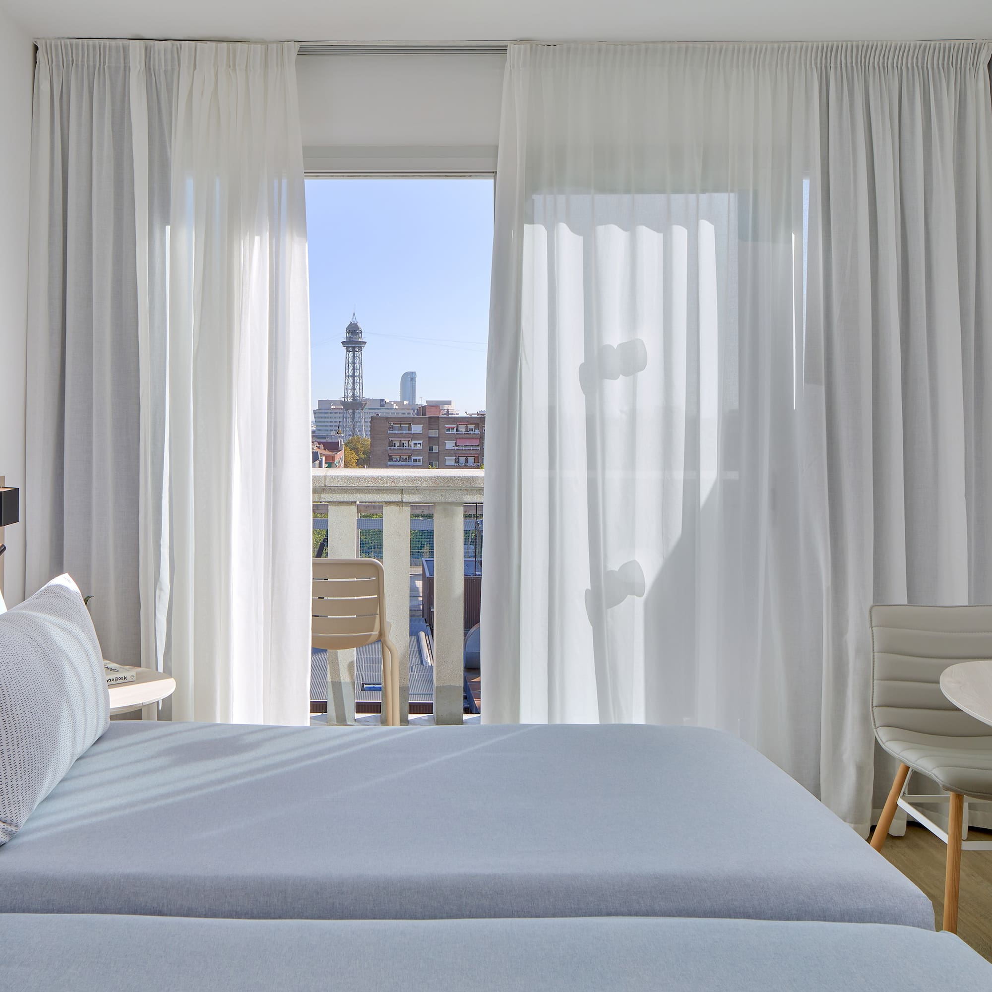 a bedroom with a table and chairs and a table and chairs