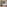 Modern hotel bedroom, large bed, wood decor, TV, mini-fridge, safe.