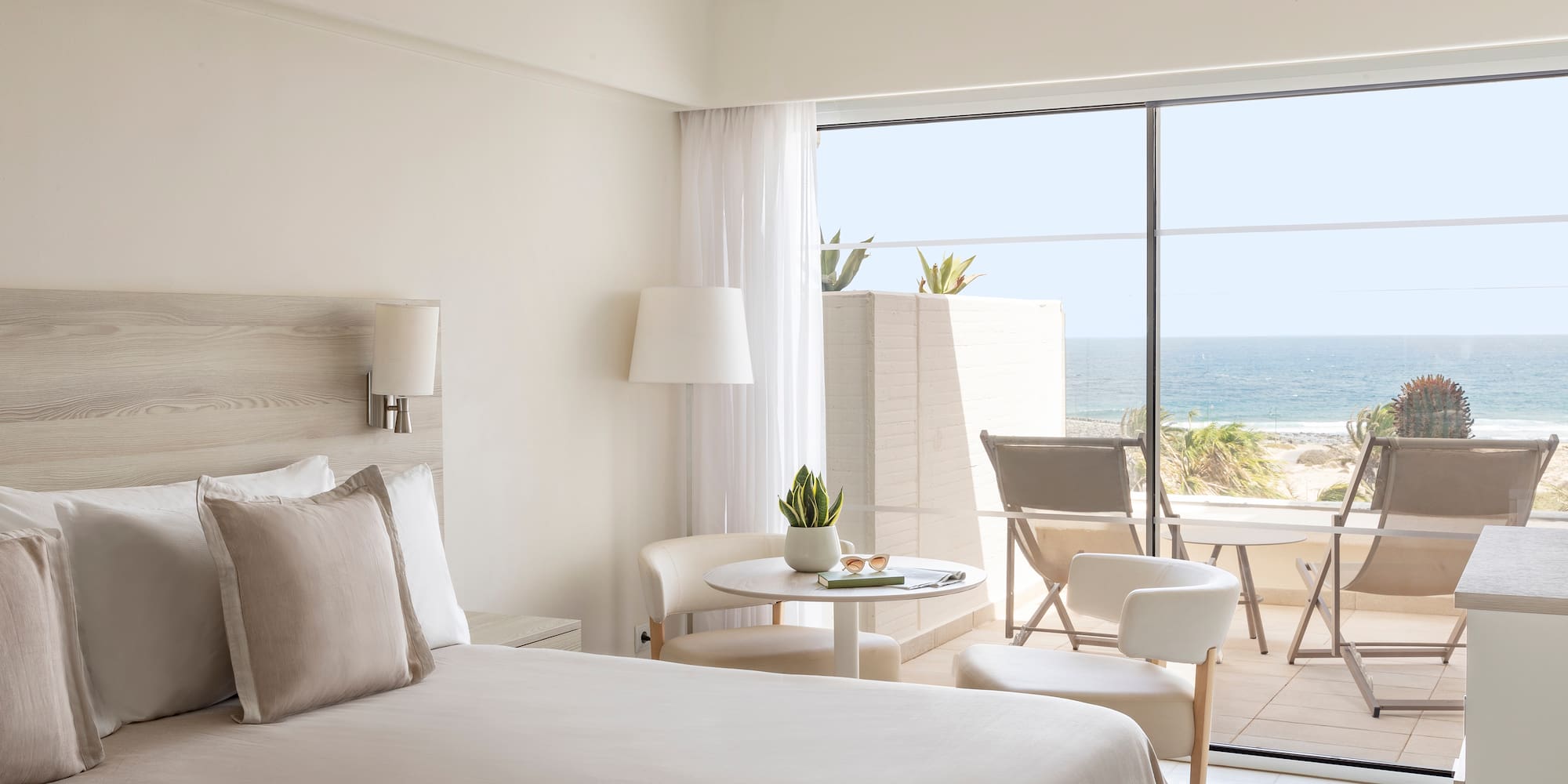 a bedroom with a glass door and a bed