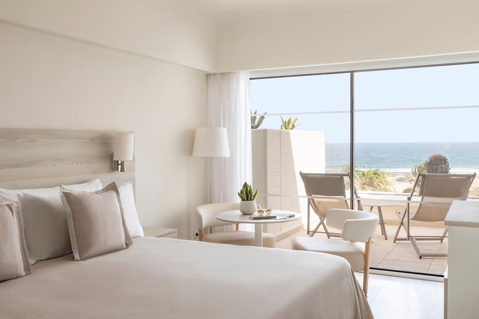 a bedroom with a glass door and a bed