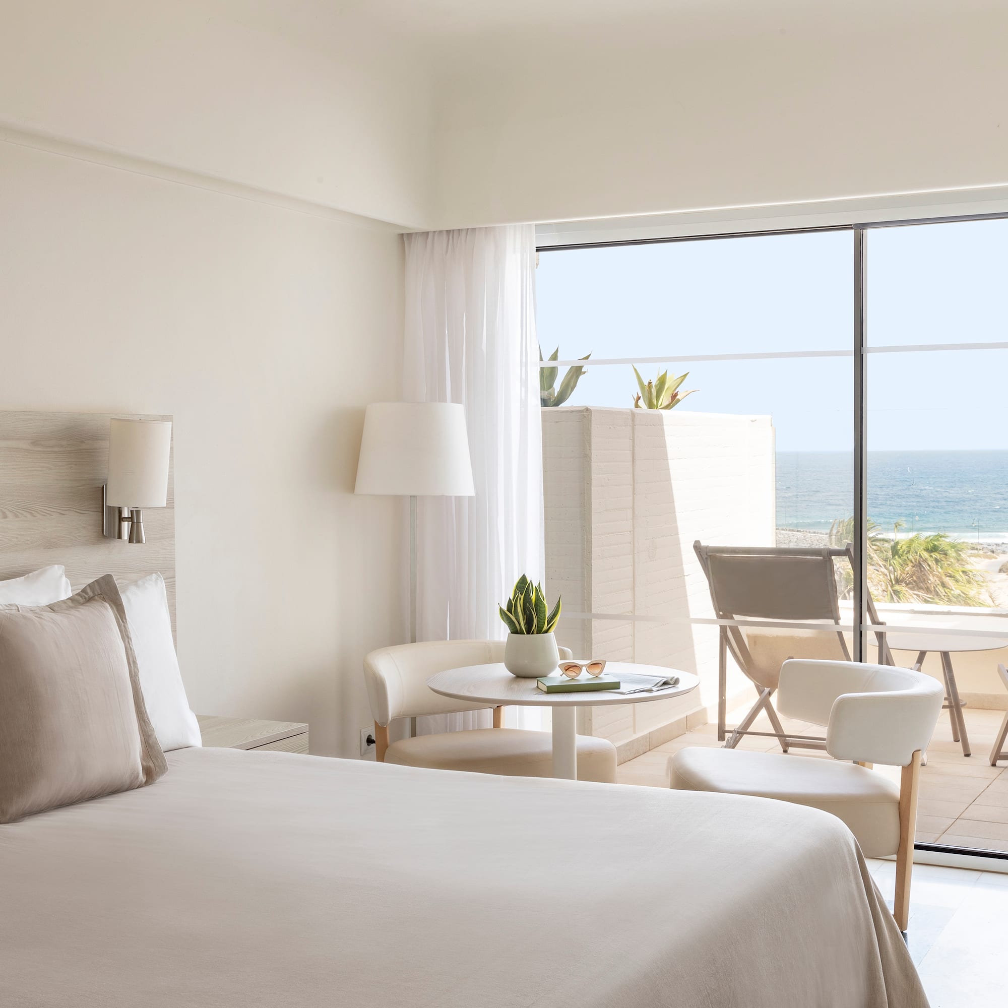 a bedroom with a glass door and a bed